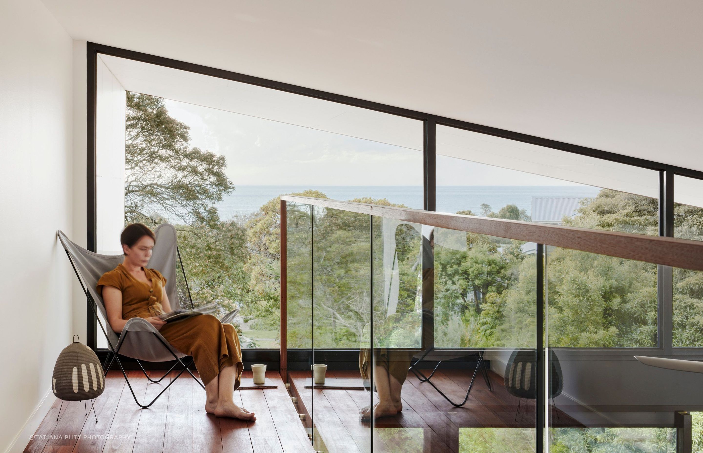 Above the kitchen, a mezzanine level takes advantage of the double-height space.