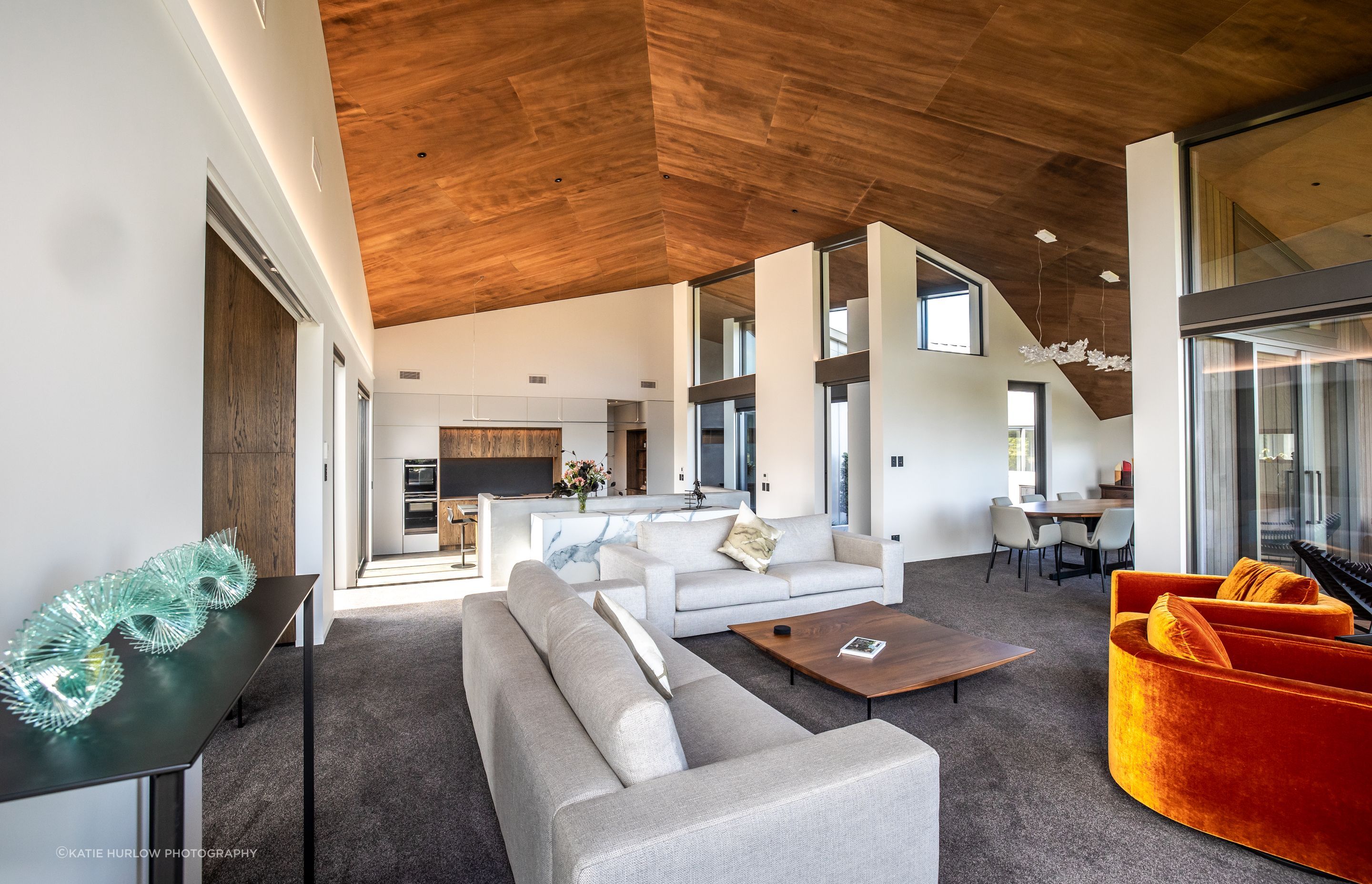 The shape of the interior is dictated by the form of the home, which opens up to the view and closes down towards the road frontage; the stunning timber ply lined ceiling accentuates the dynamic, sculptural form of the home.