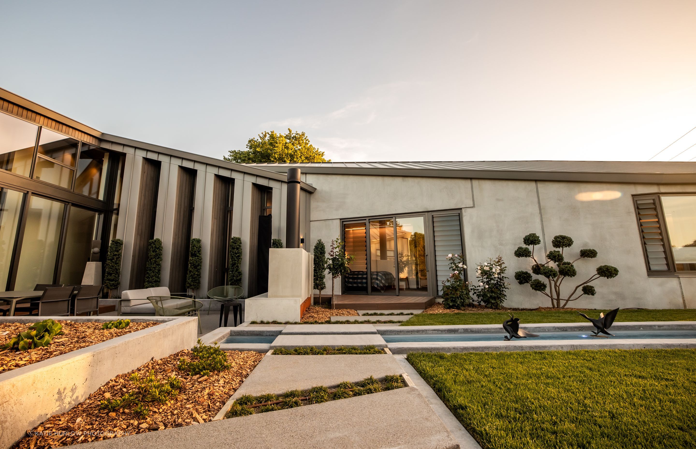 The clients' love of gardening is evident in the beautifully landscaped exterior, which was designed to accentuate the different wings of the home.