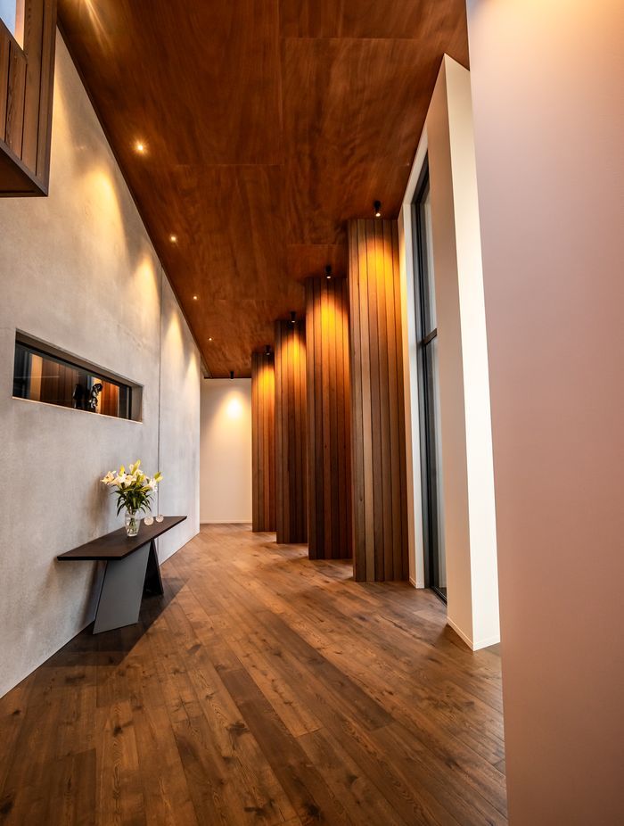 The timber fins in an internal corridor break up the journey to the bedrooms, creating enticing snapshots of the stunning view.