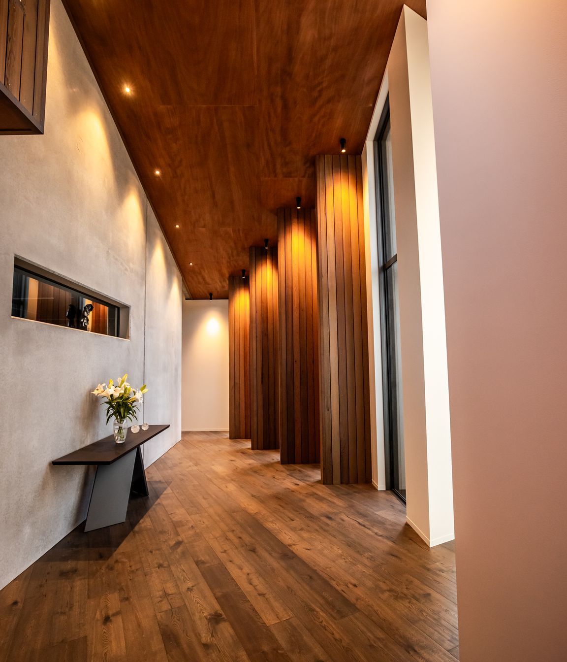 The timber fins in an internal corridor break up the journey to the bedrooms, creating enticing snapshots of the stunning view.