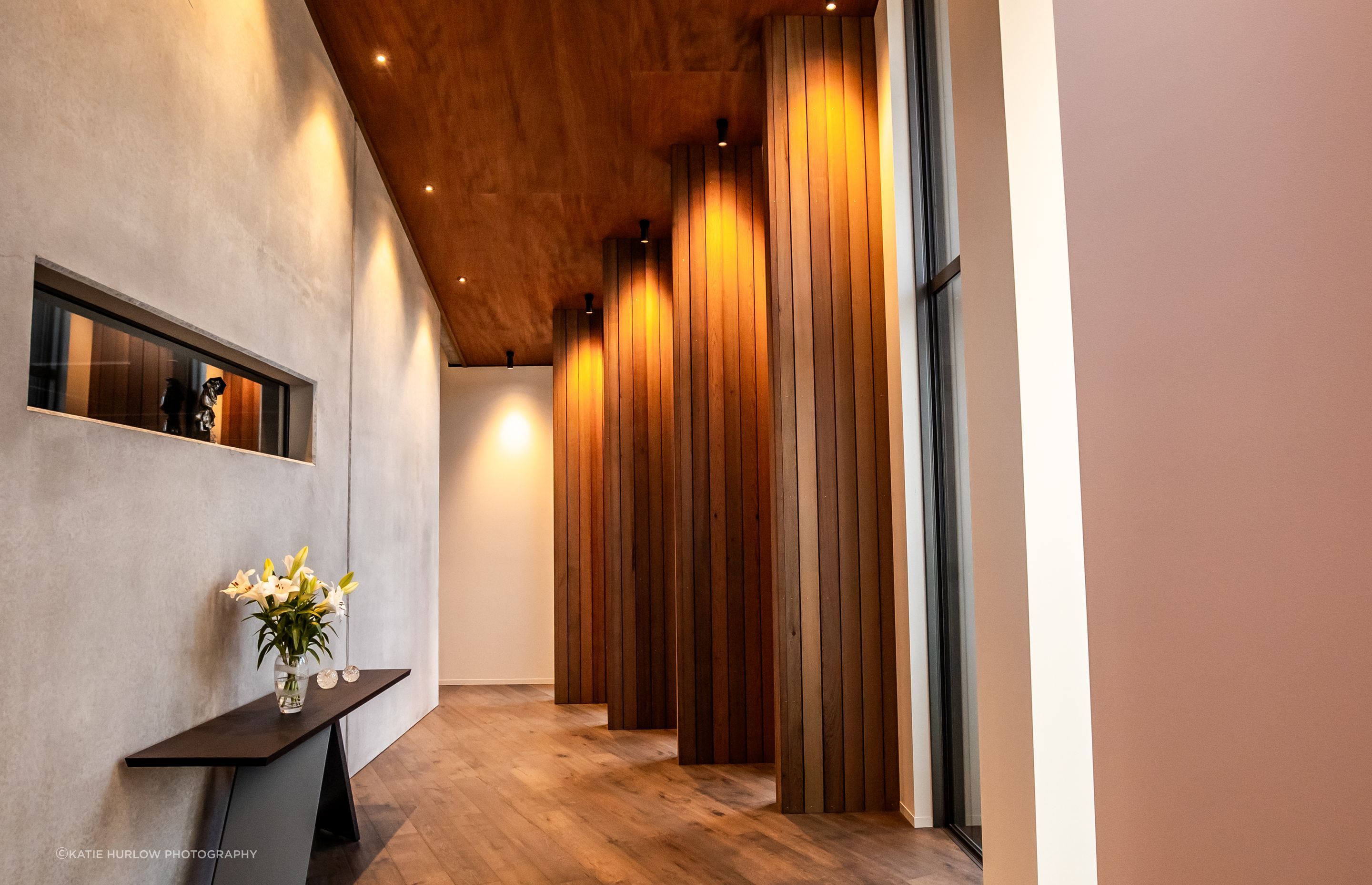 The timber fins in an internal corridor break up the journey to the bedrooms, creating enticing snapshots of the stunning view.