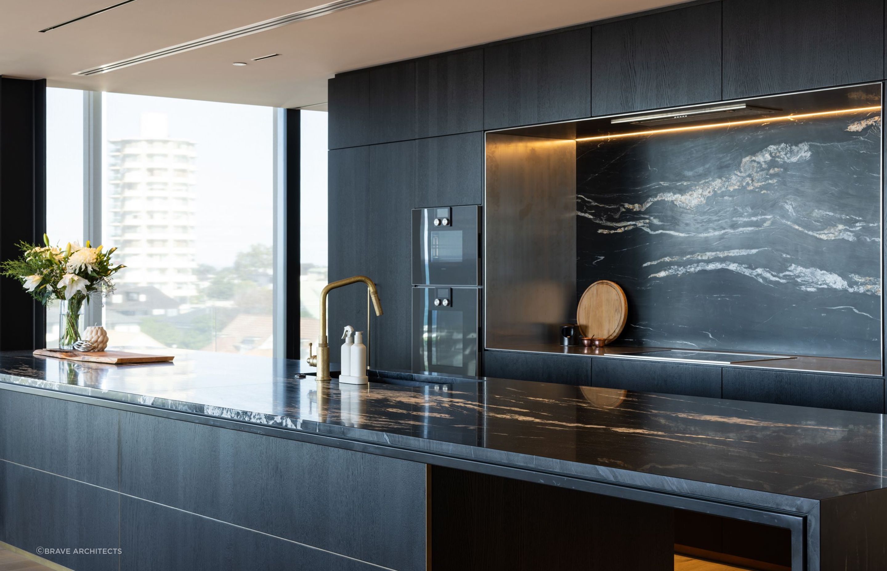 The Milton 110 penthouse makes a bold statement with its dark kitchen.