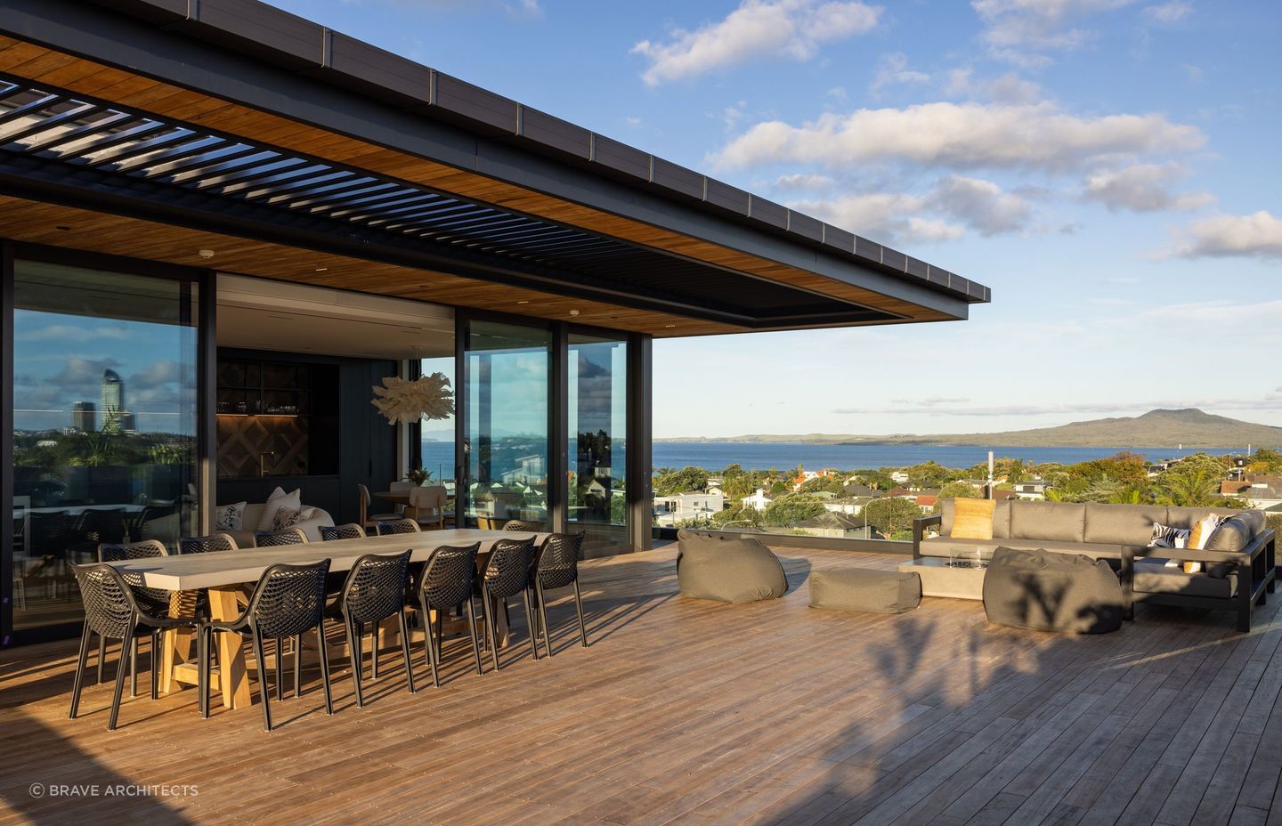 The deck is complete with plenty of seating, a fire pit, and a breathtaking view of Rangitoto.