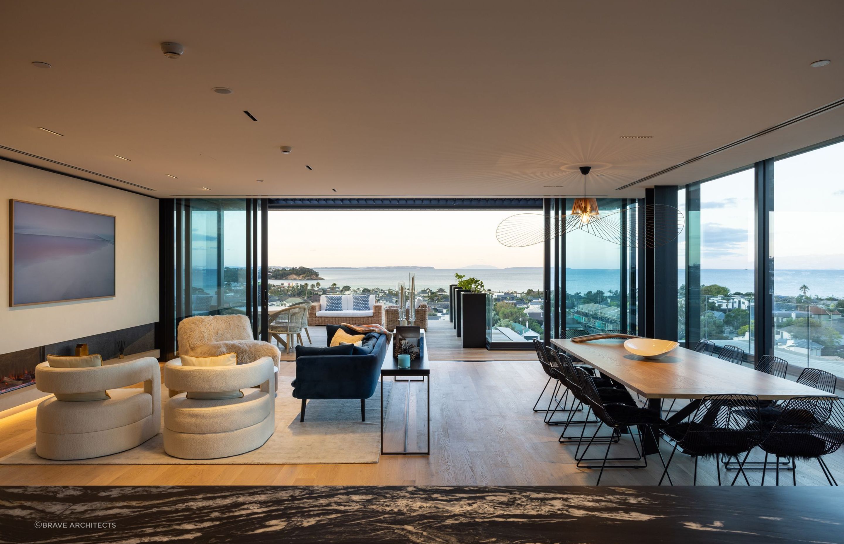 The open-plan kitchen, living and dining area overlooks the water.