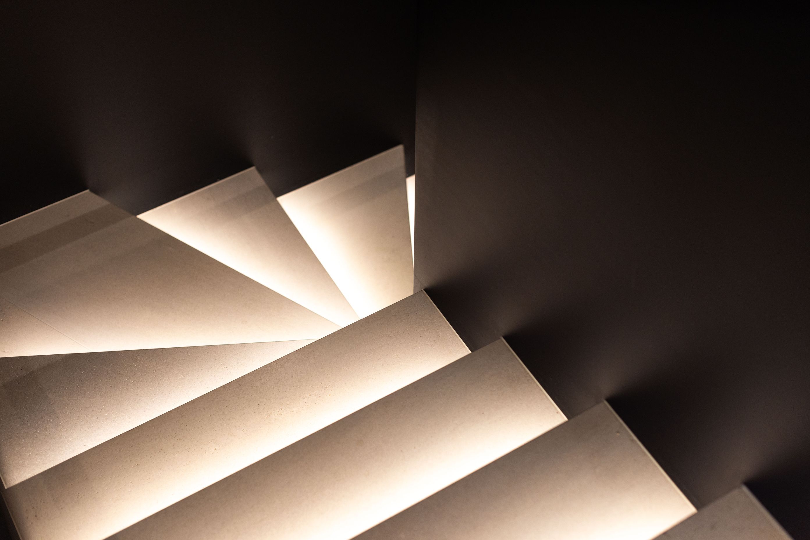The treads on the steel stairwell are up-lit with LED lighting, creating a sculptural effect.