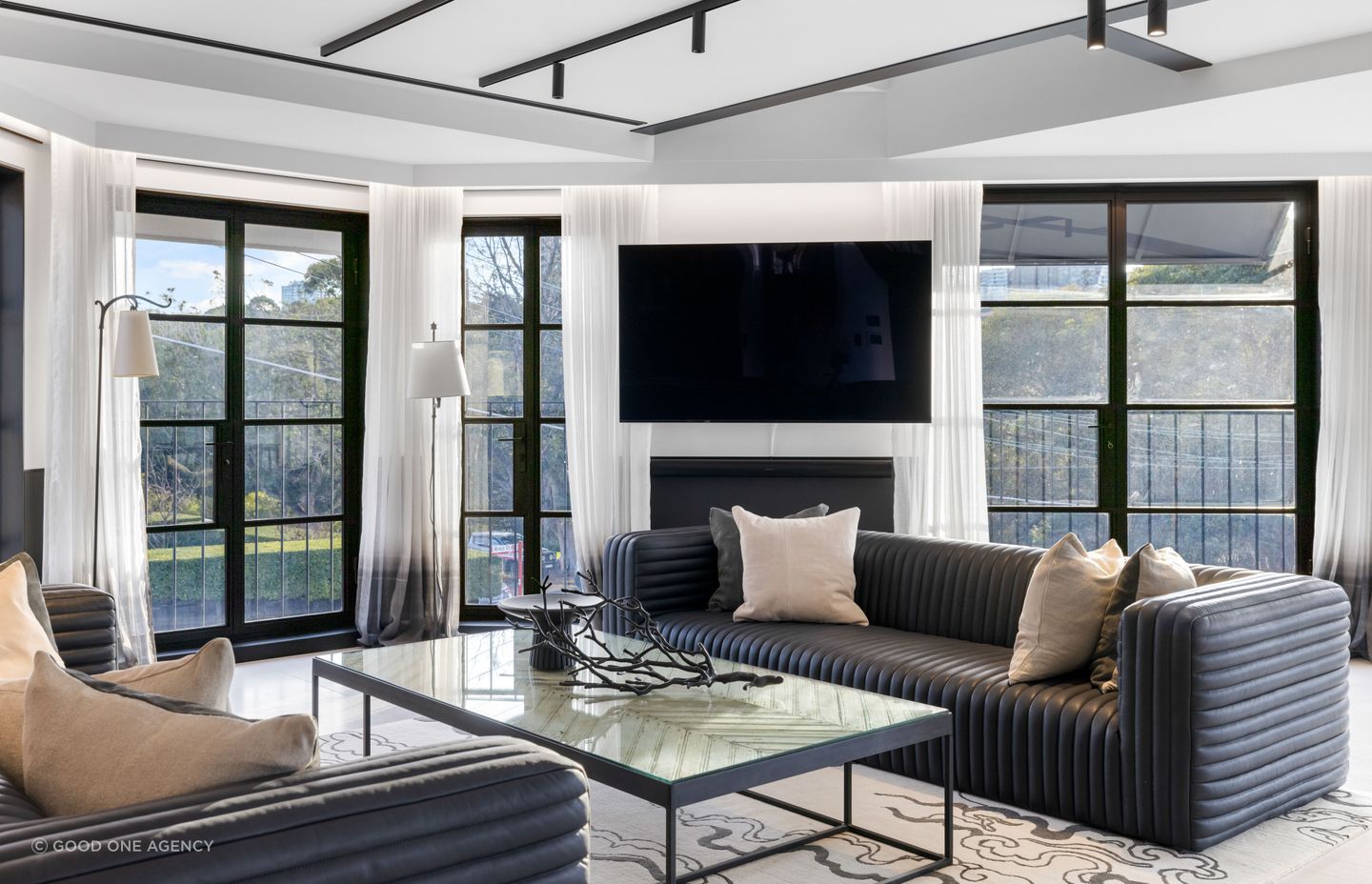 Soft Belgian linen drapes with an ombre effect soften the harder elements of the living space.