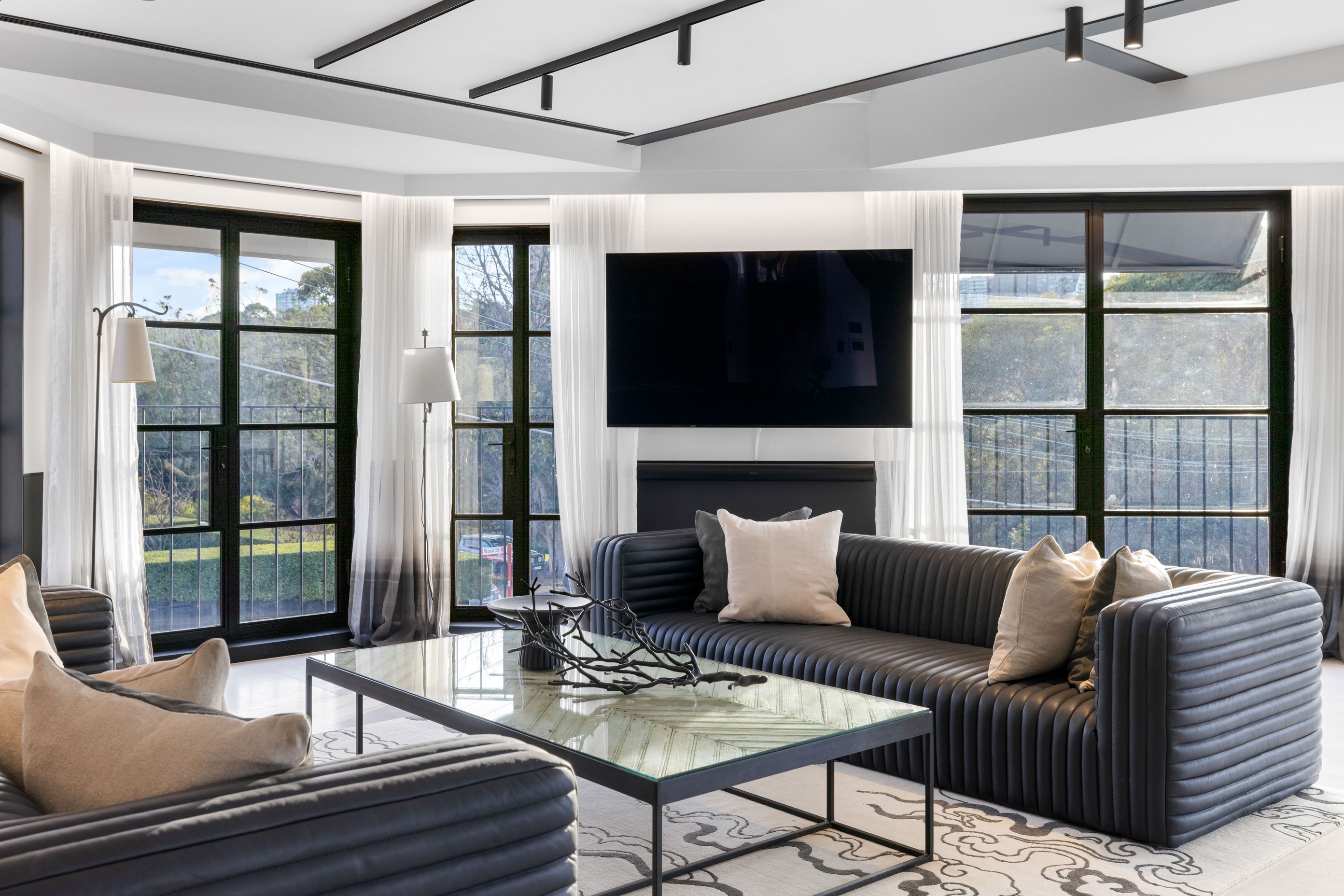 Soft Belgian linen drapes with an ombre effect soften the harder elements of the living space.