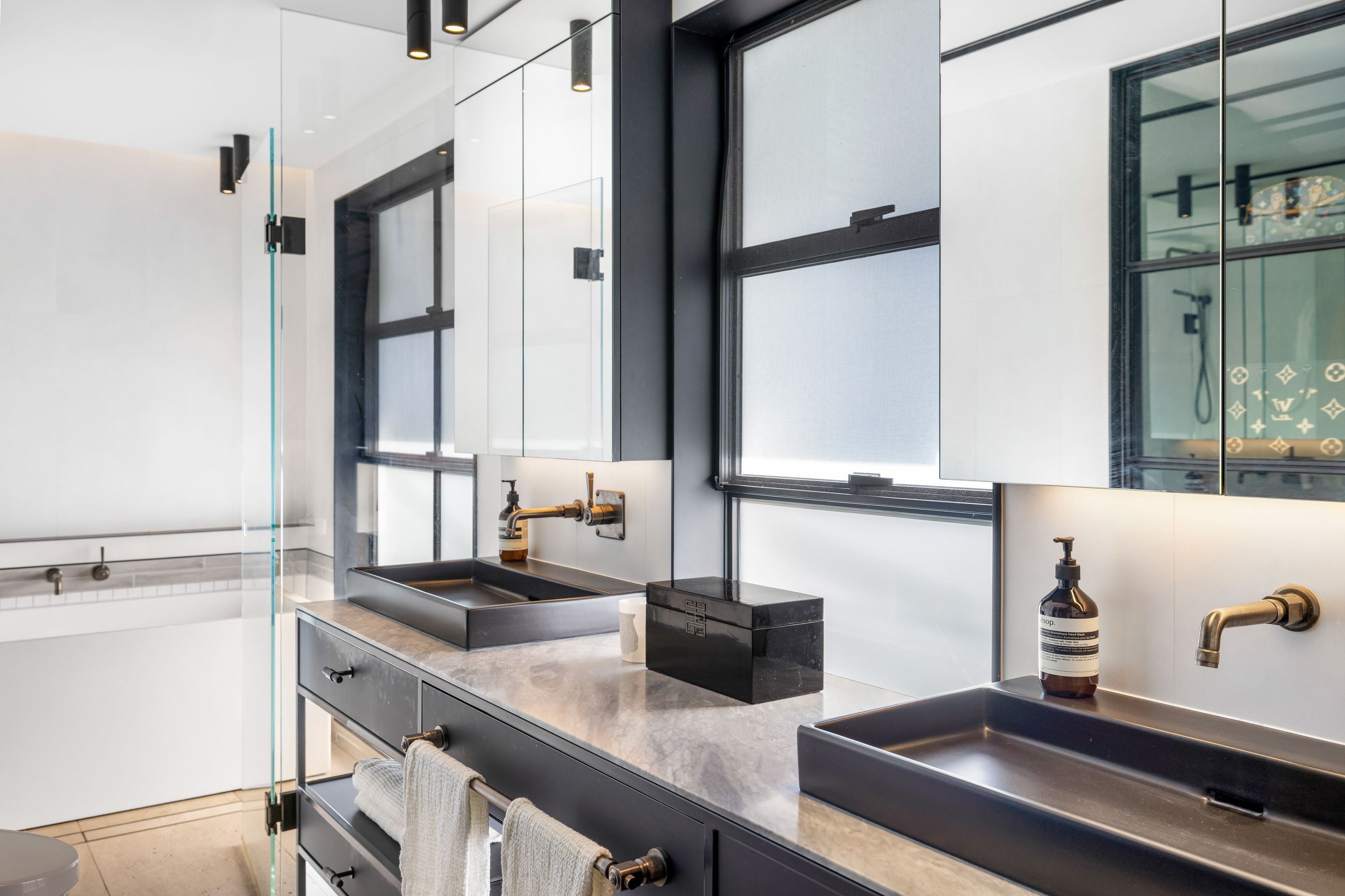 Steel and glass elements create a sleek look in the master ensuite.