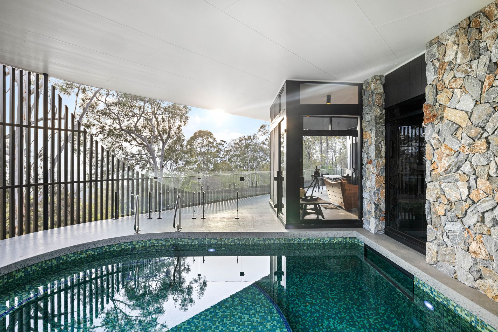 The aluminium batten facade is cut away on one side to reveal the view.