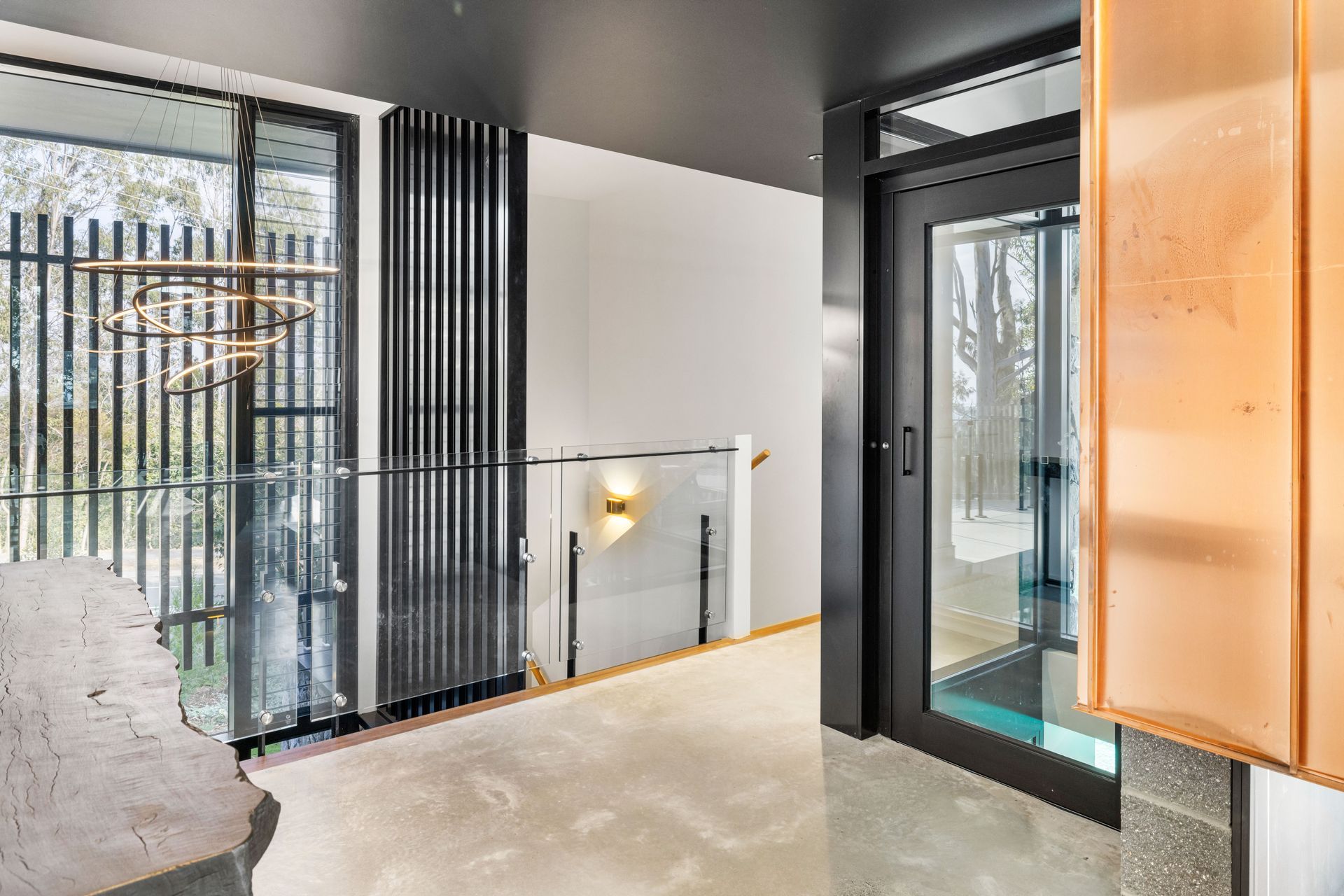 The glass lift takes in the view of the pool as it ascends.