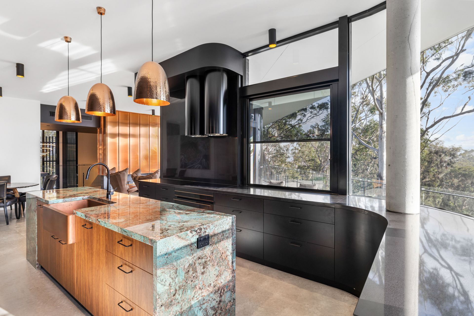 The green tones of the central island's Amazonite benchtop draw in the hues in nature.