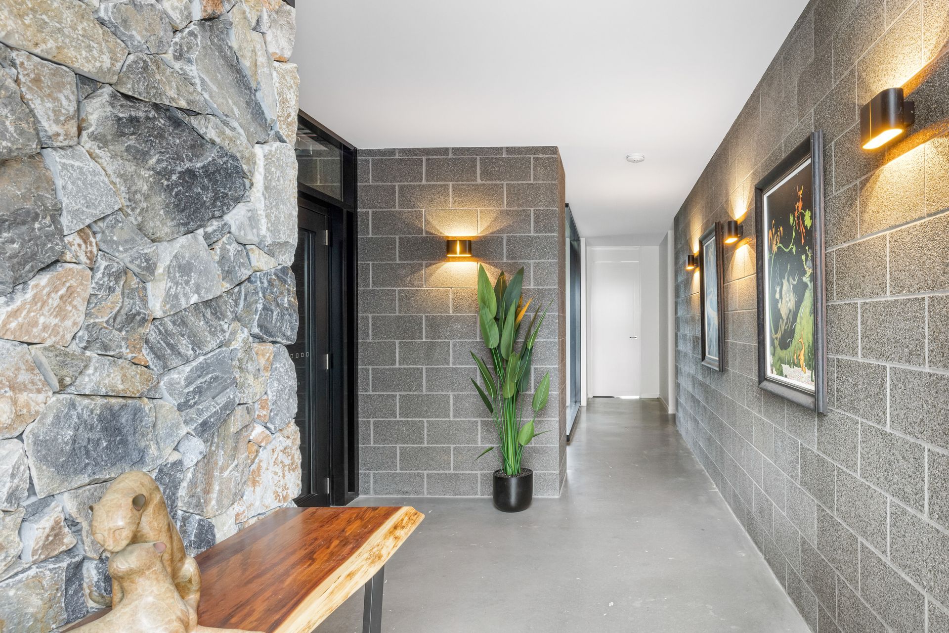The stone walls and blockwork weave in from outside, creating a seamless transition between interior and exterior.