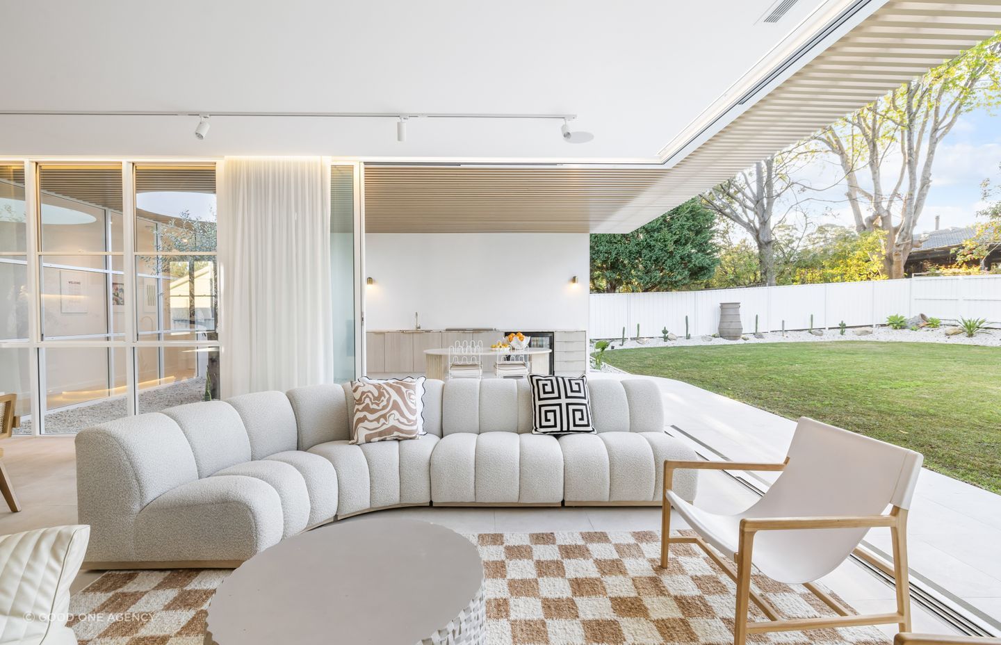 The lounge space flows seamlessly to an outdoor kitchen.