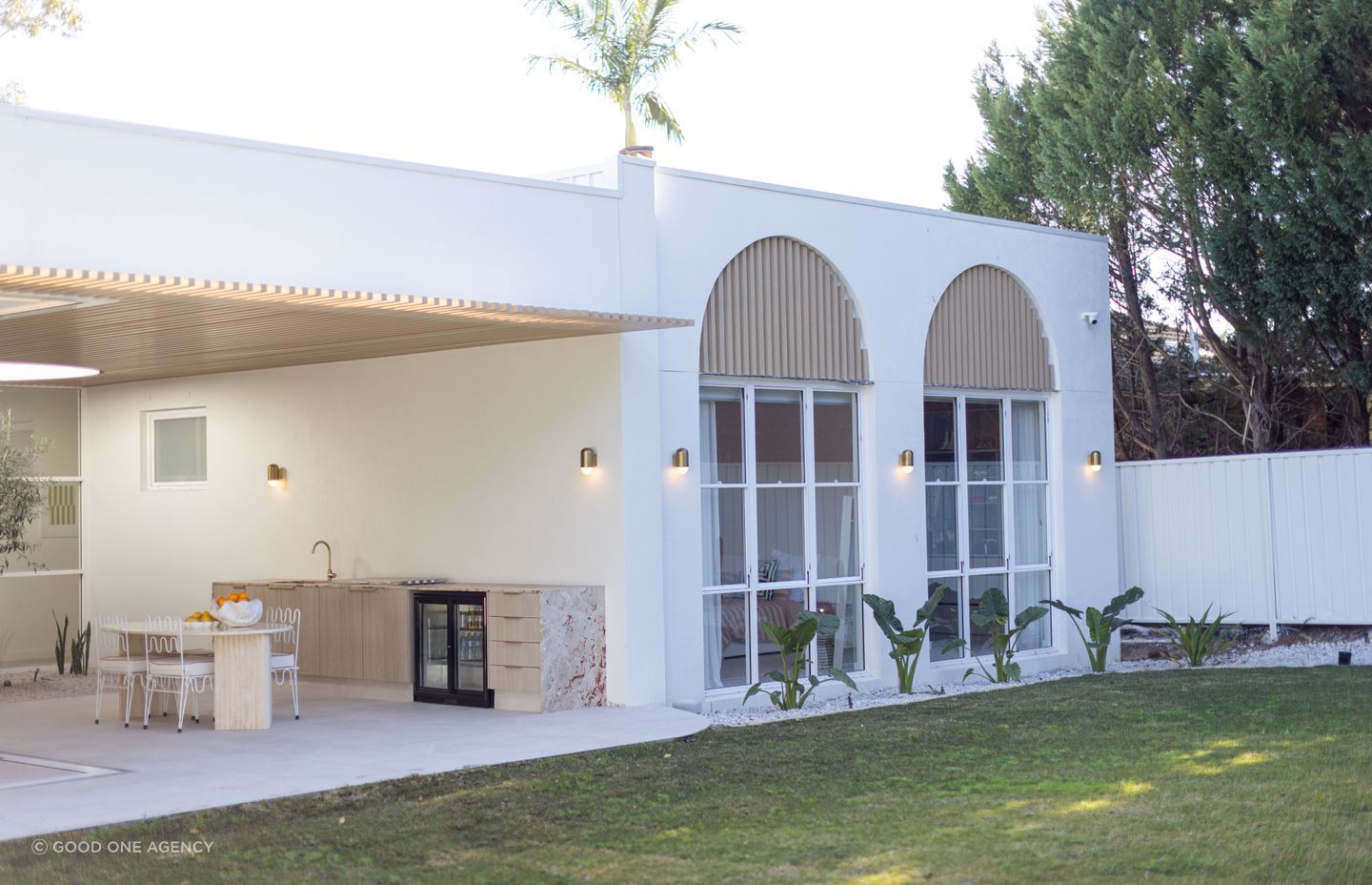 The exterior at the back of the home celebrates the arches found in Mediterranean architecture, while remaining contemporary in style.