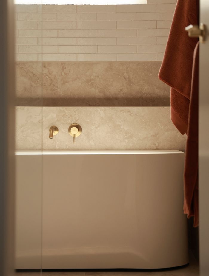 Every detail has been considered, with brass fixtures and a niche for easy reach while in the bathtub.