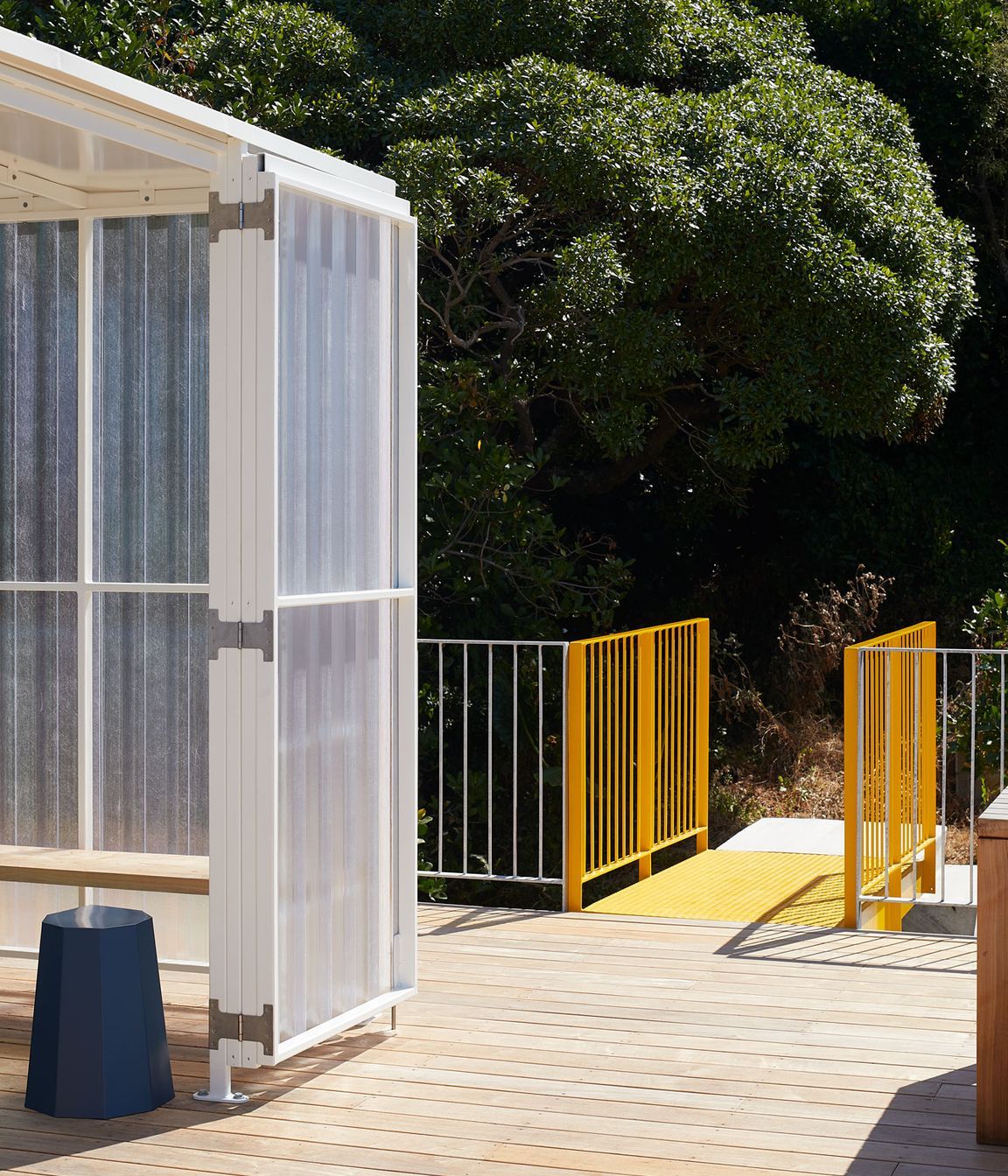 The yellow metal bridge provides access to the roof deck.