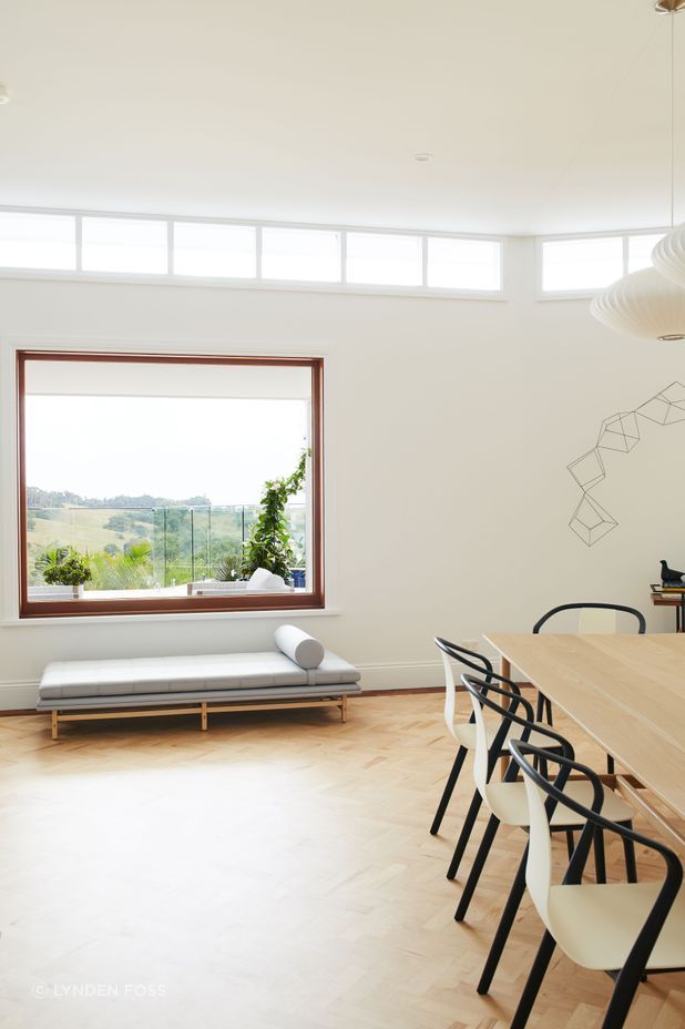 The clerestory windows were framed with dark timber before the renovation, but have now been painted white to let the views shine.