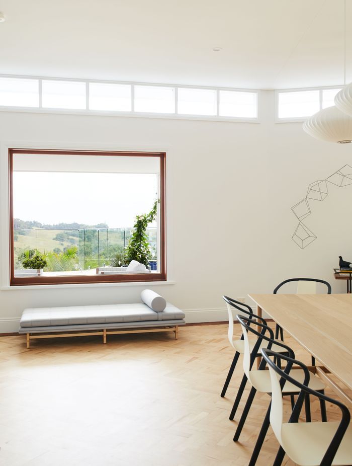 The clerestory windows were framed with dark timber before the renovation, but have now been painted white to let the views shine.