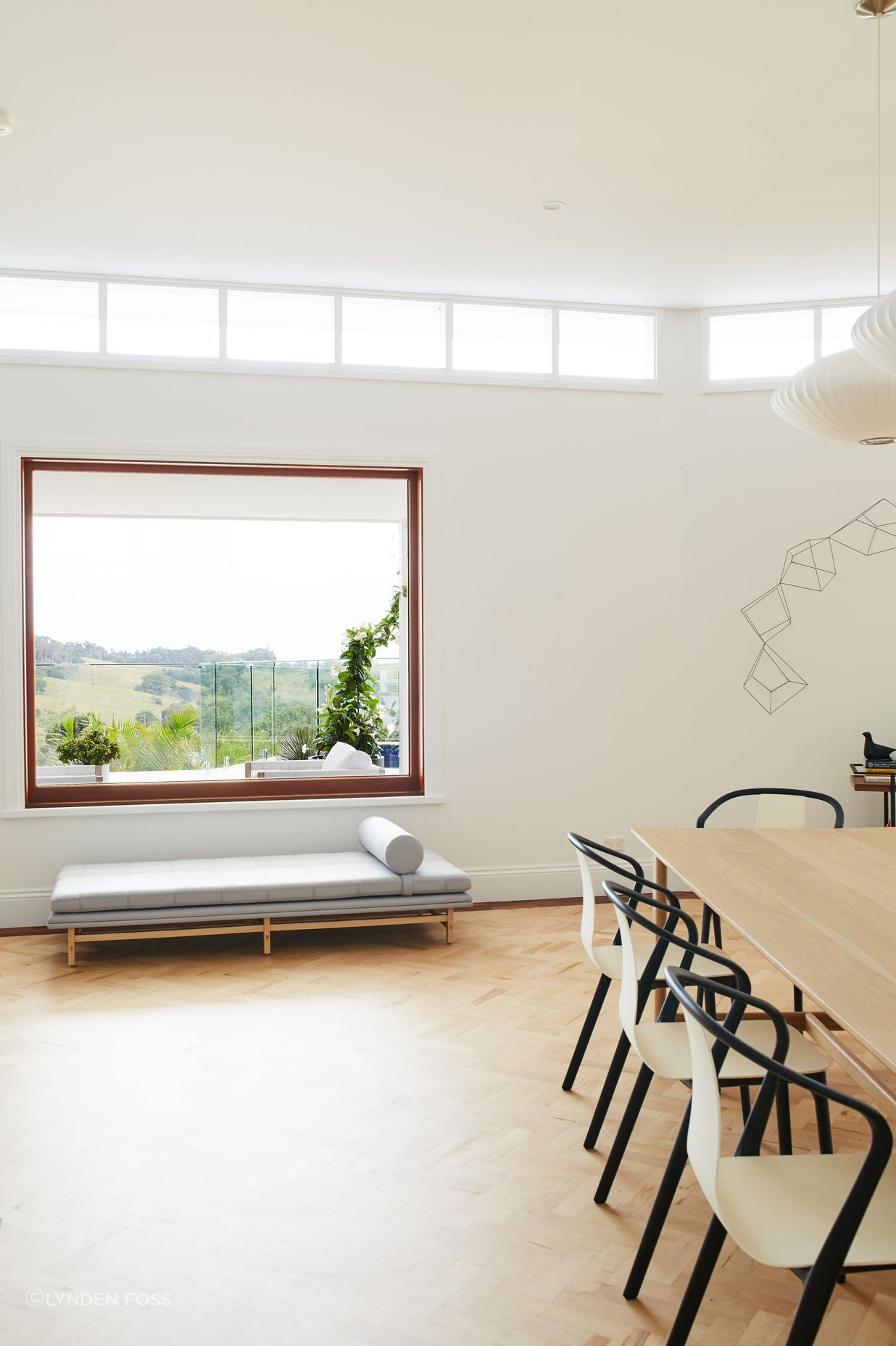 The clerestory windows were framed with dark timber before the renovation, but have now been painted white to let the views shine.