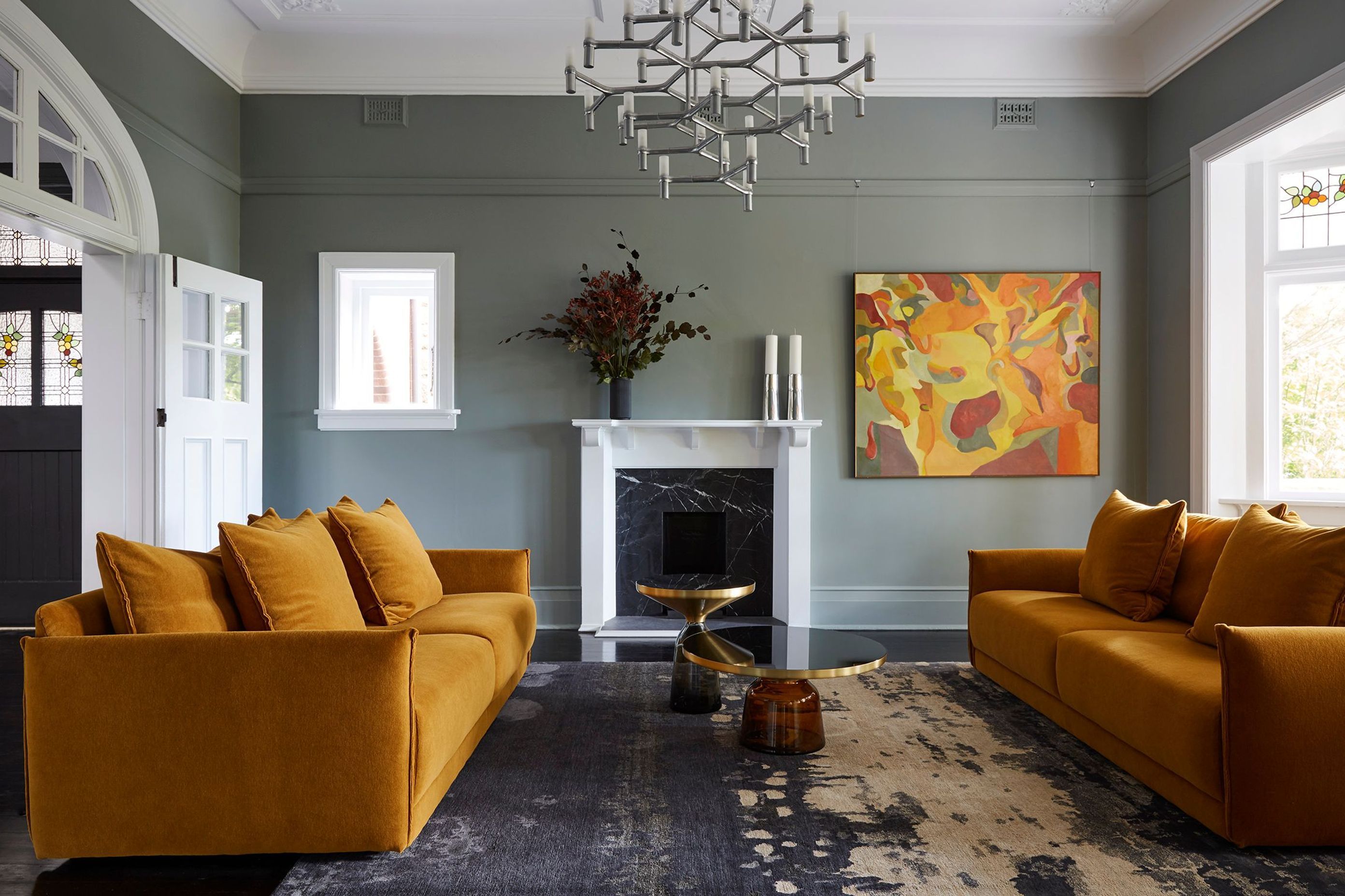 The formal lounge features custom velvet sofas in jewel tones that pick out the colours on the artwork.