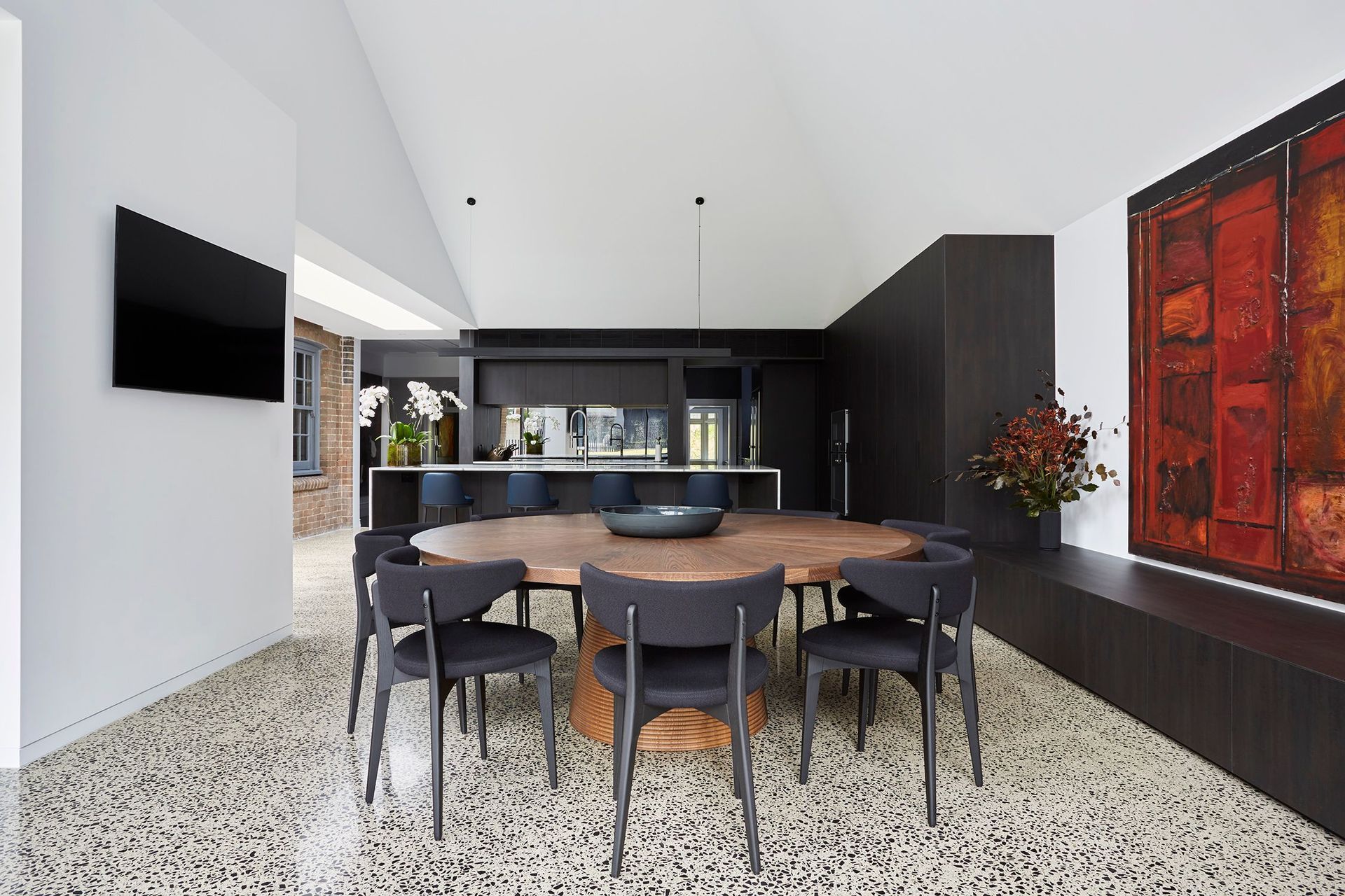 A circular timber table for casual dining grounds the new space.