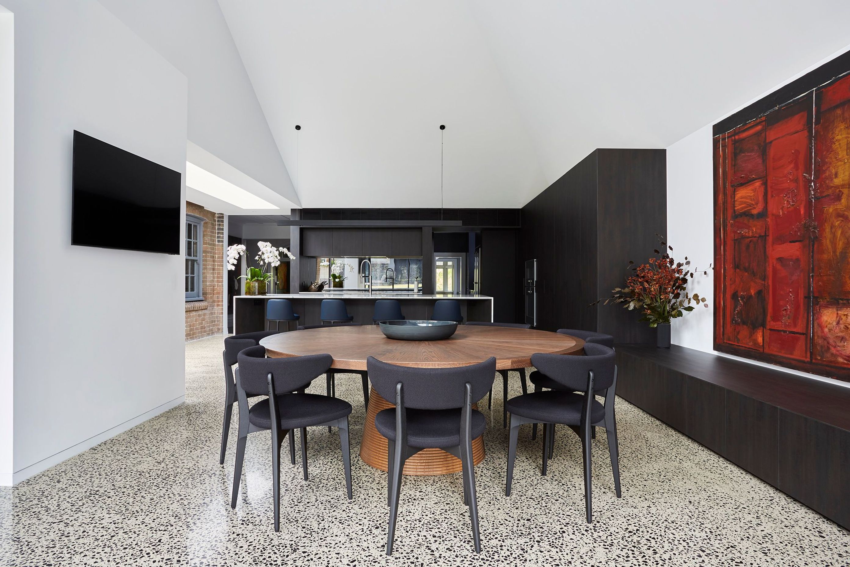 A circular timber table for casual dining grounds the new space.