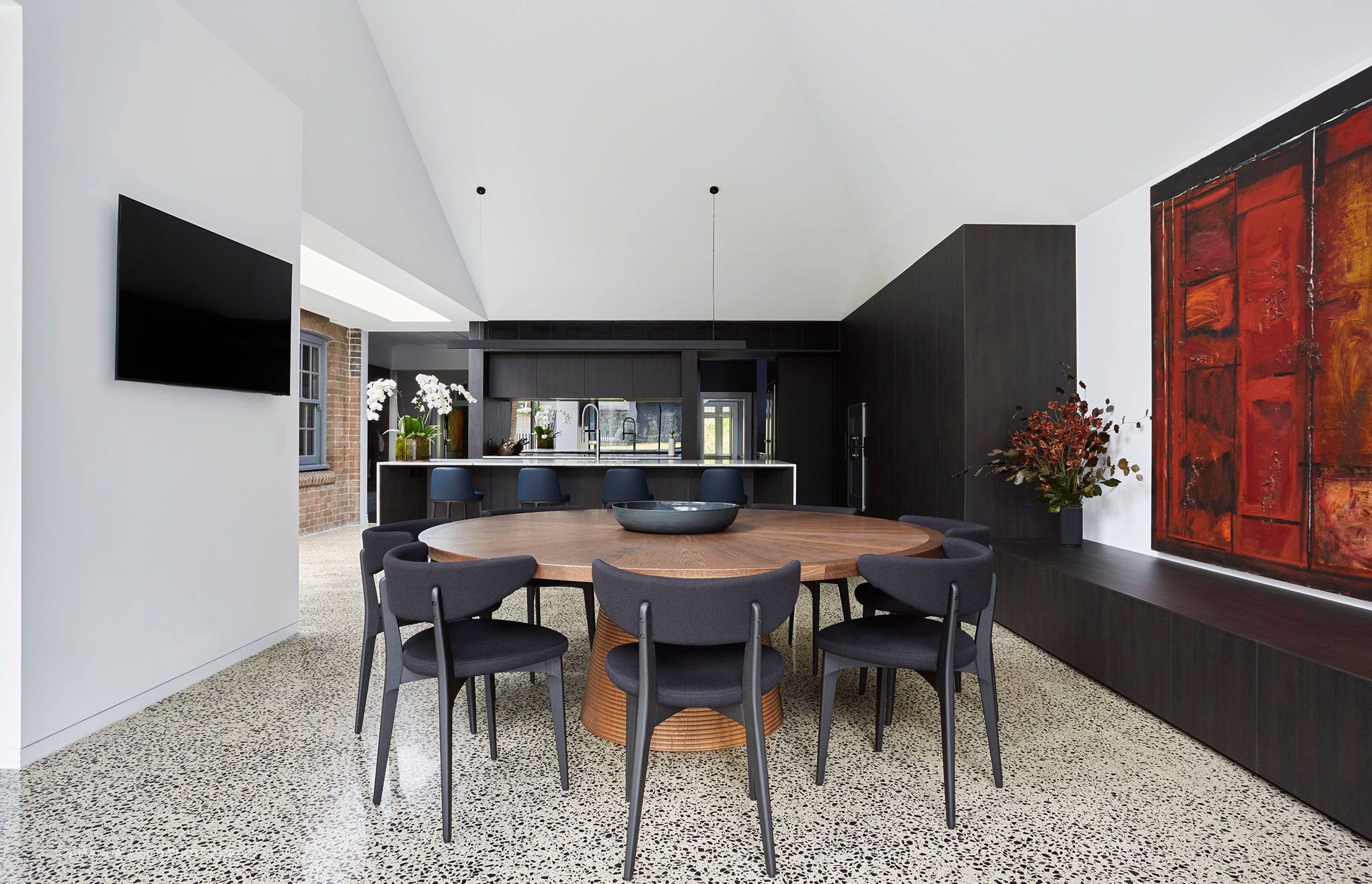 A circular timber table for casual dining grounds the new space.