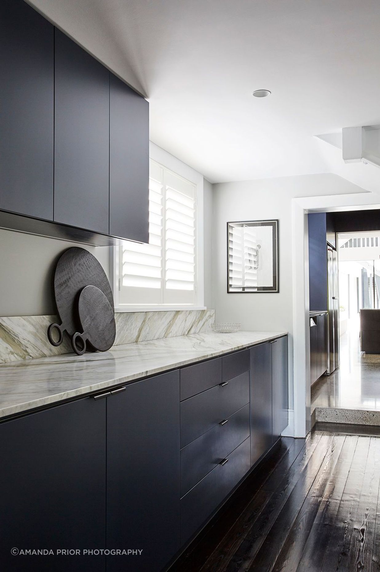 The Butler's laundry uses the same materiality as the kitchen.