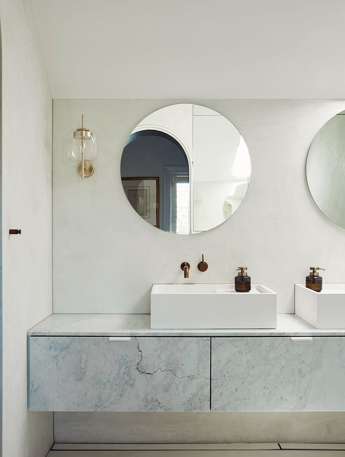 The master ensuite uses curves and a pale palette for a sophisticated and serene bathing space.
