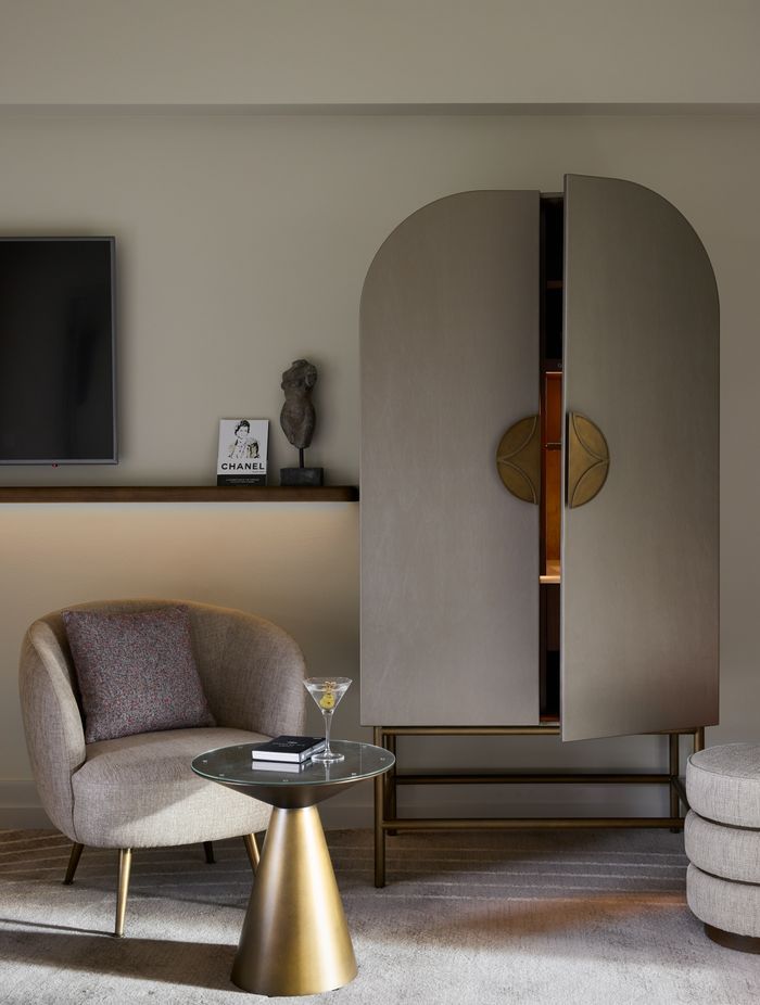 Custom Art Nouveau cabinetry conceals the minibar.