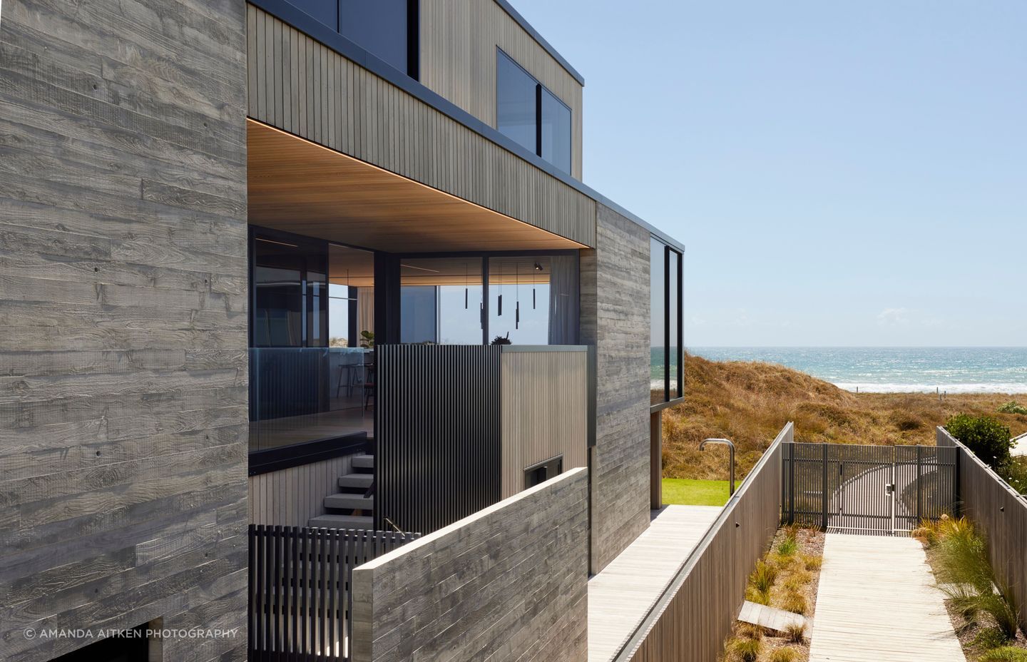With shops and cafes on the street side, the house acts as a bridge between the urban and the coastal. The boardwalk access is only for residents of the development.