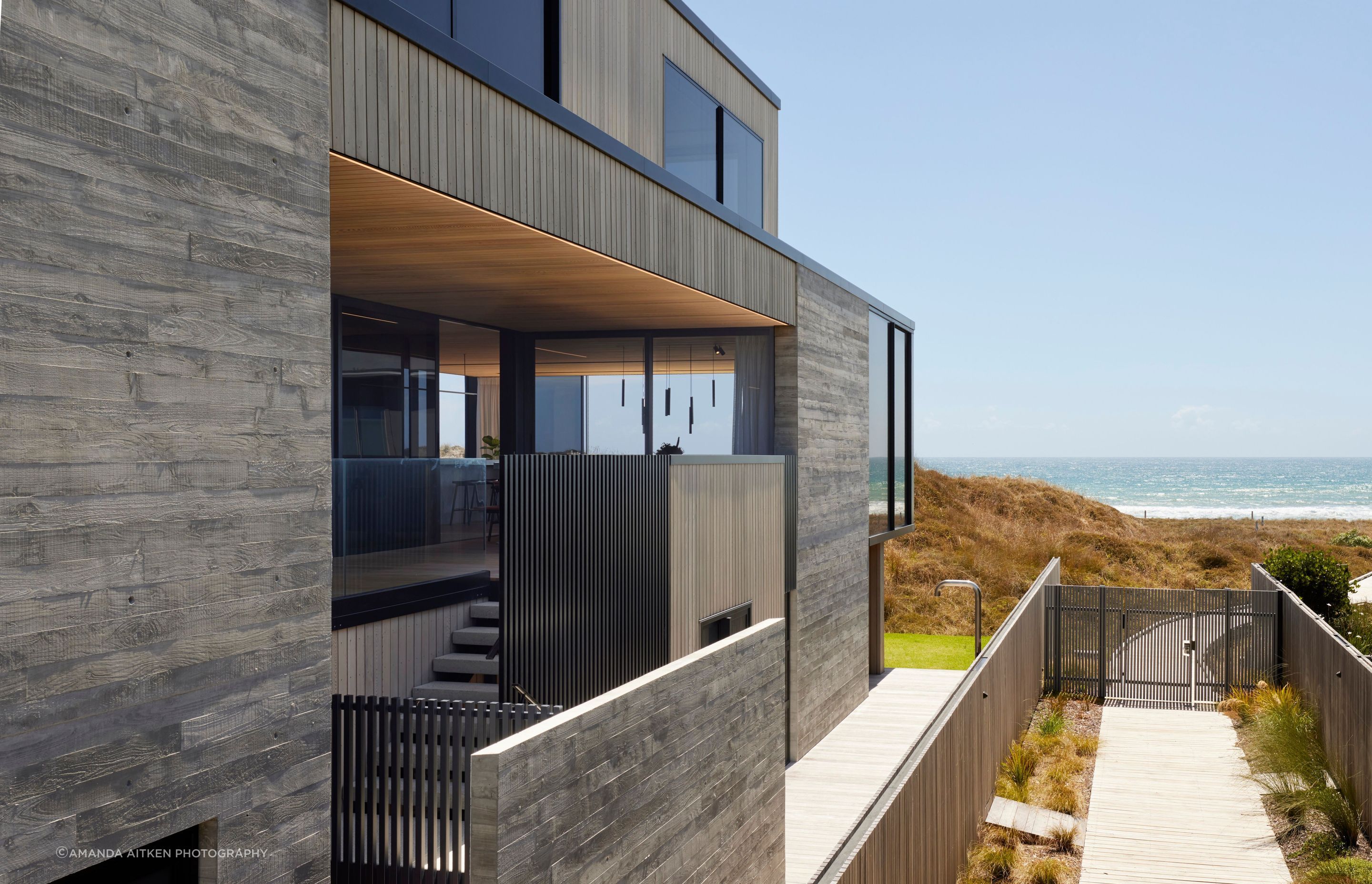 With shops and cafes on the street side, the house acts as a bridge between the urban and the coastal. The boardwalk access is only for residents of the development.