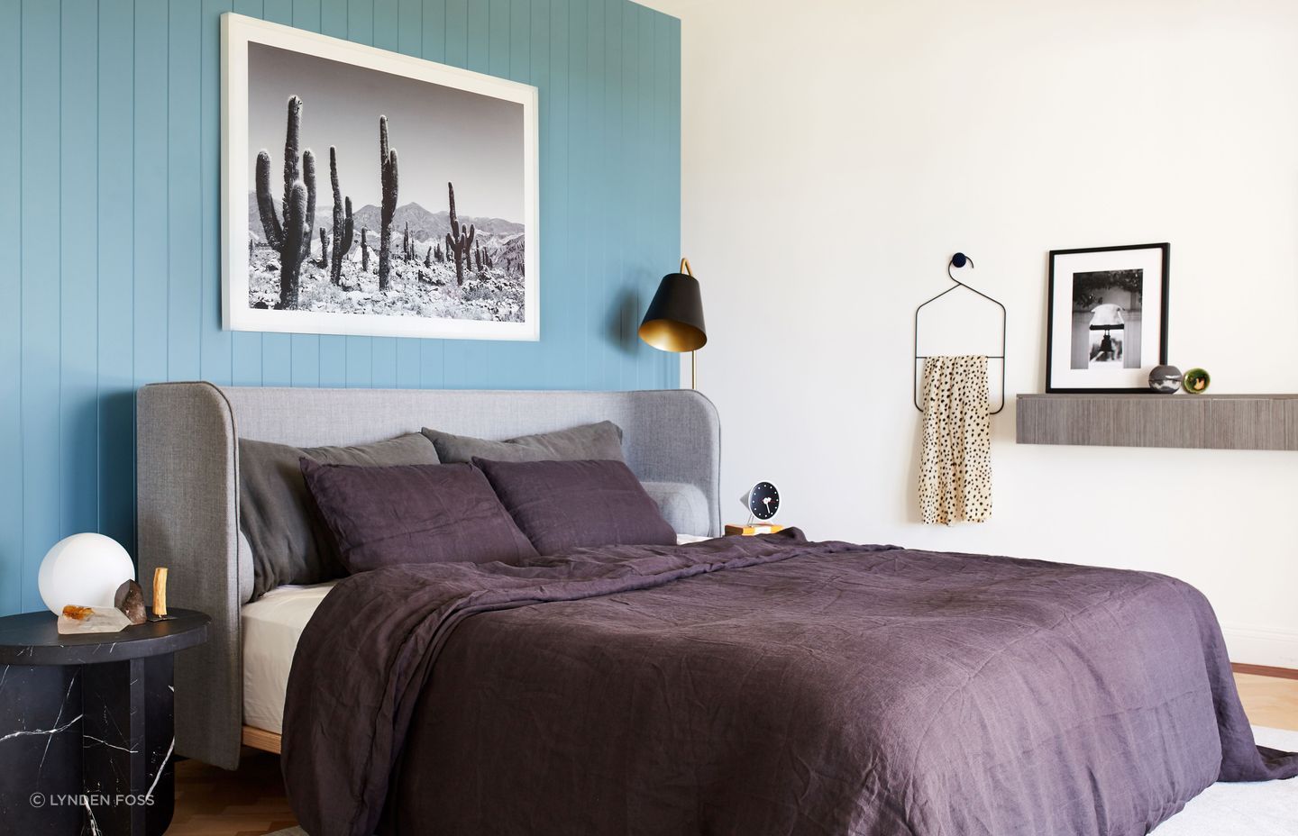 The same teal colour used on the kitchen cabinetry offers a stunning backdrop to the bed in the master bedroom.
