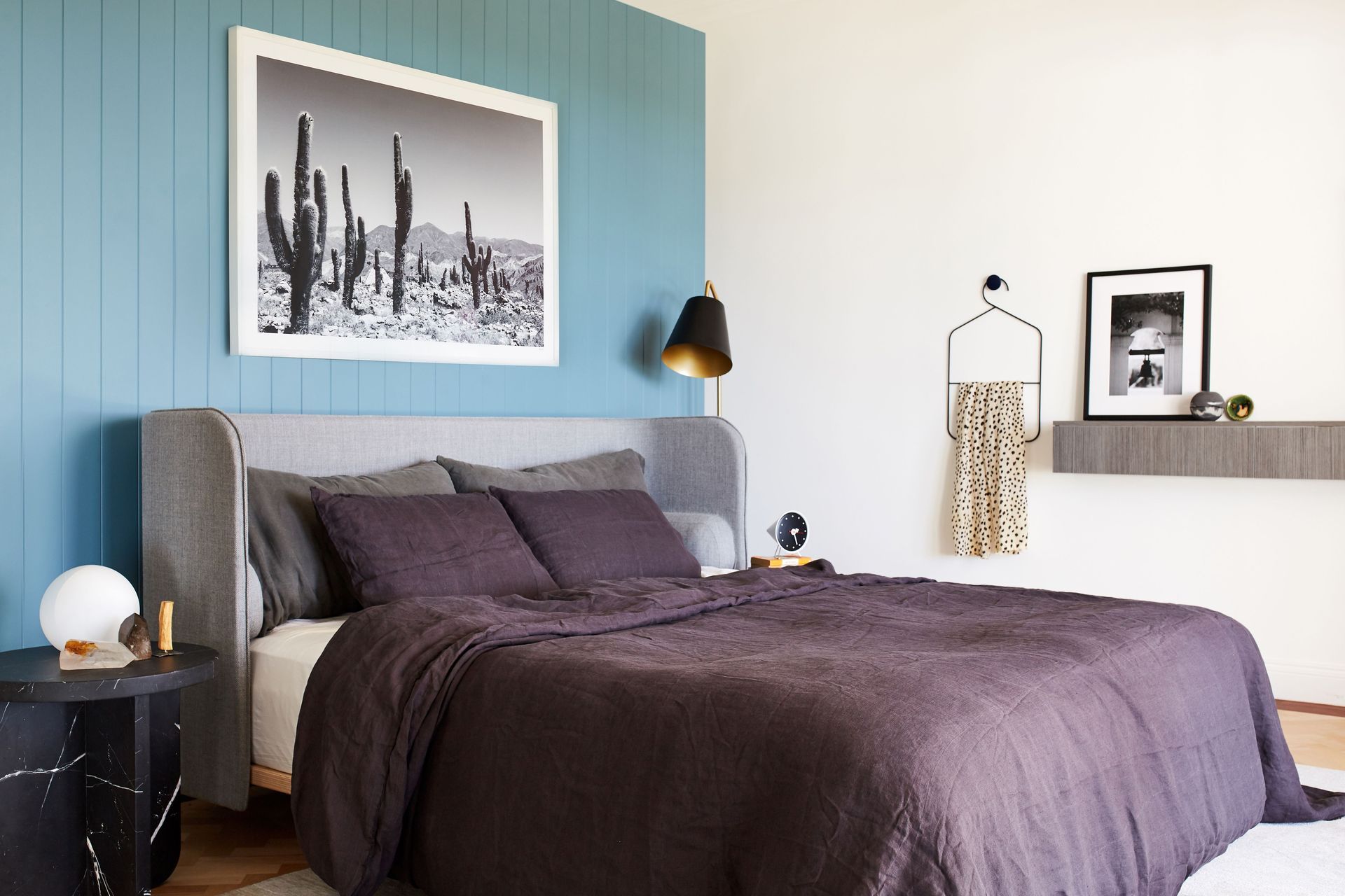 The same teal colour used on the kitchen cabinetry offers a stunning backdrop to the bed in the master bedroom.