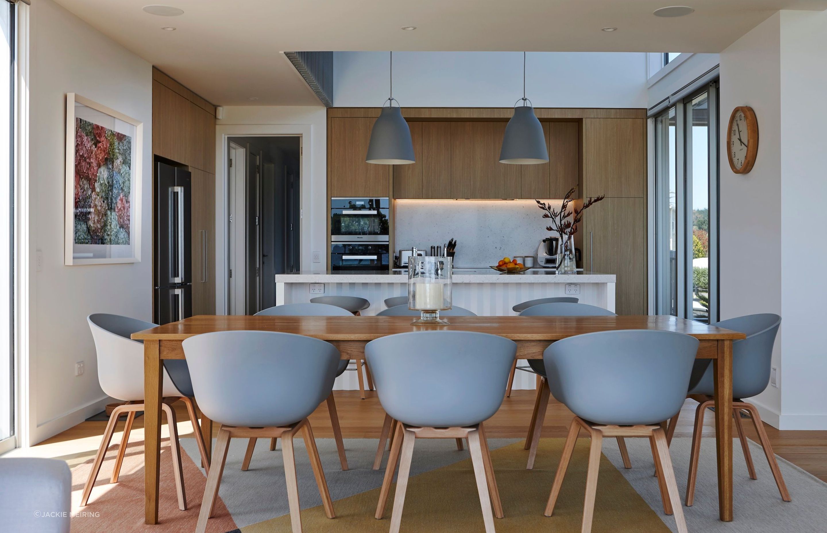 In the kitchen, Caravaggio pendants and Hay dining chairs and bar stools are from Cult.