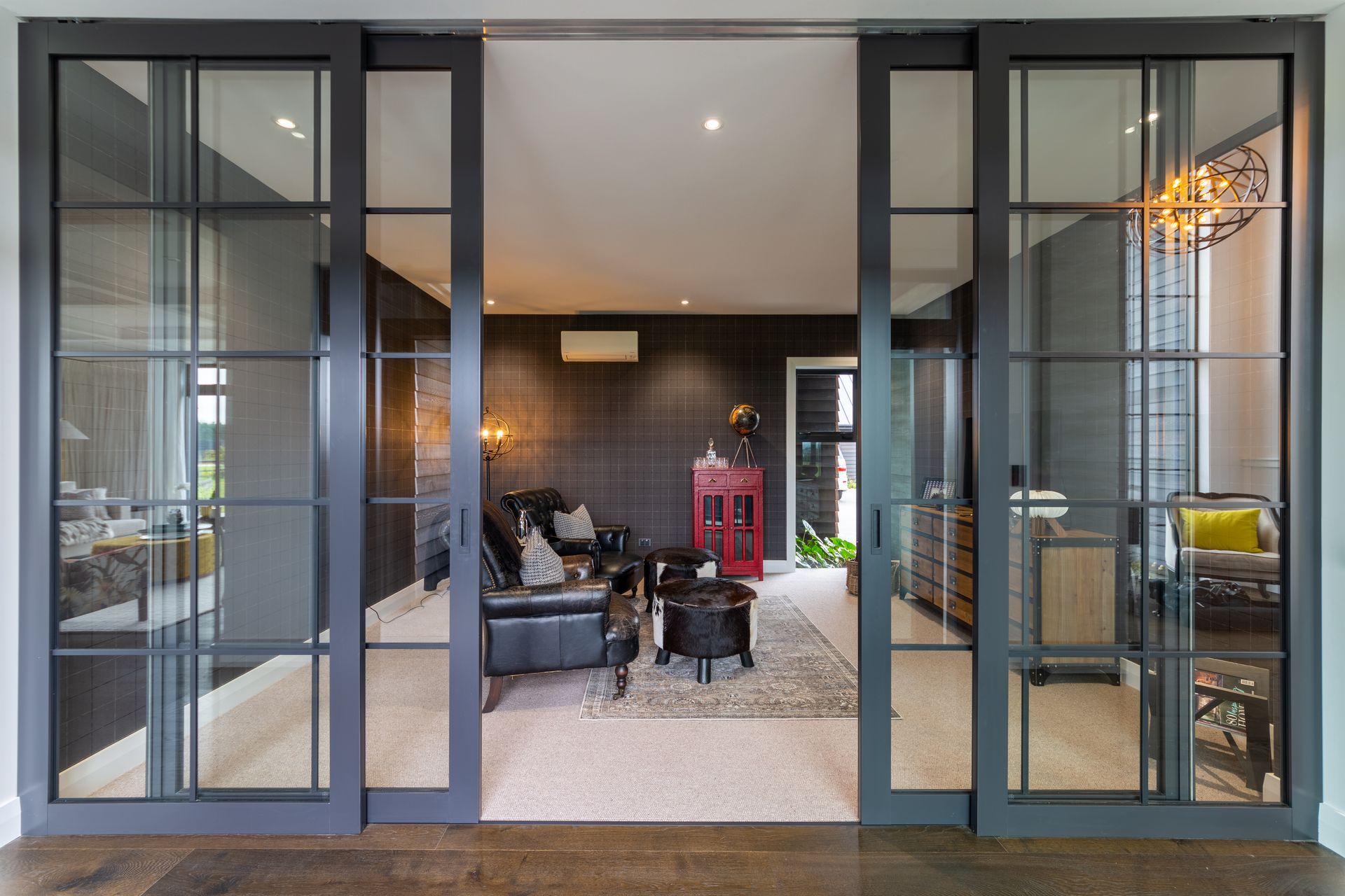 Internal joinery separates the snug adult's whiskey lounge lounge from the hallway.