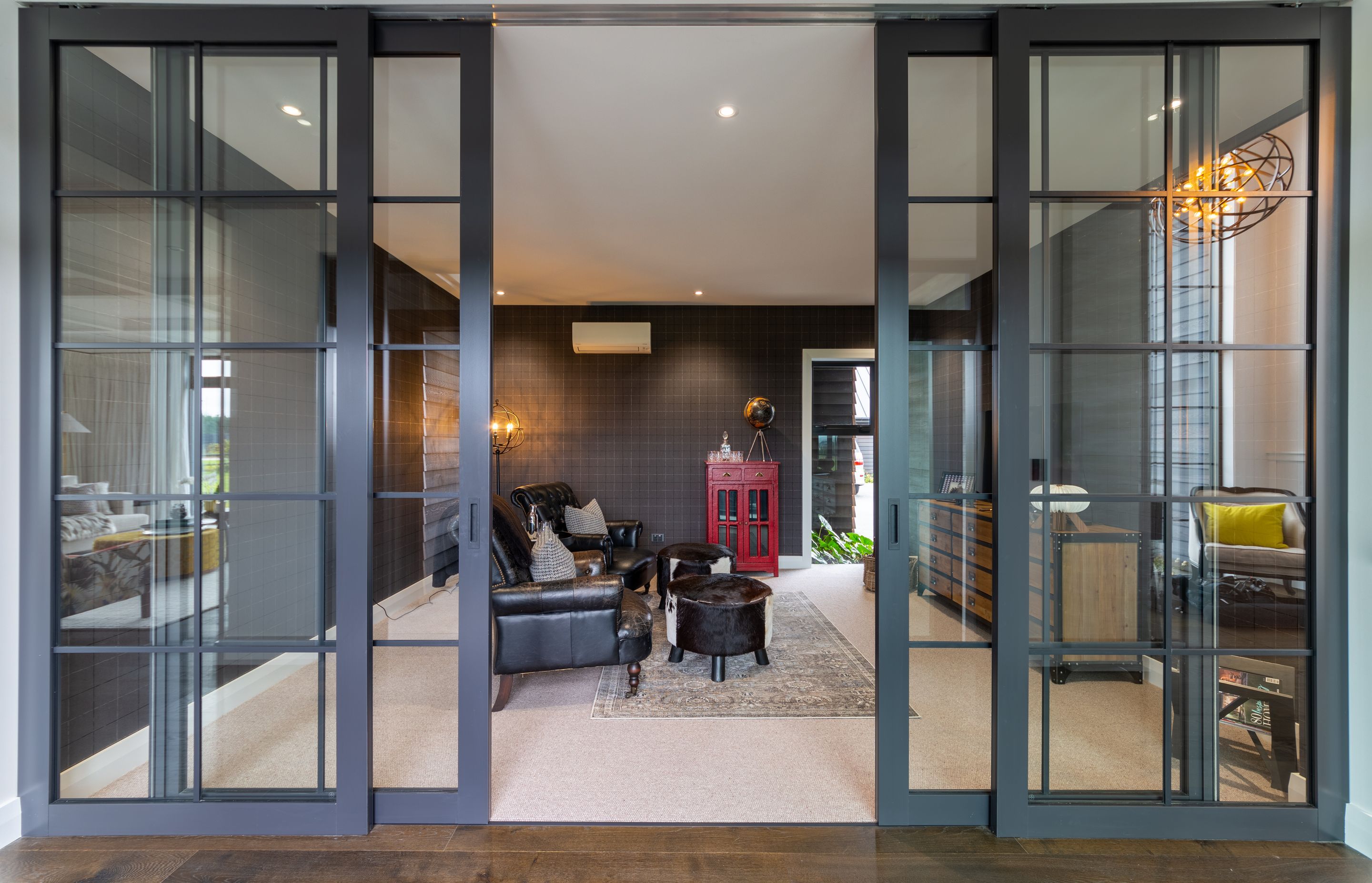 Internal joinery separates the snug adult's whiskey lounge lounge from the hallway.