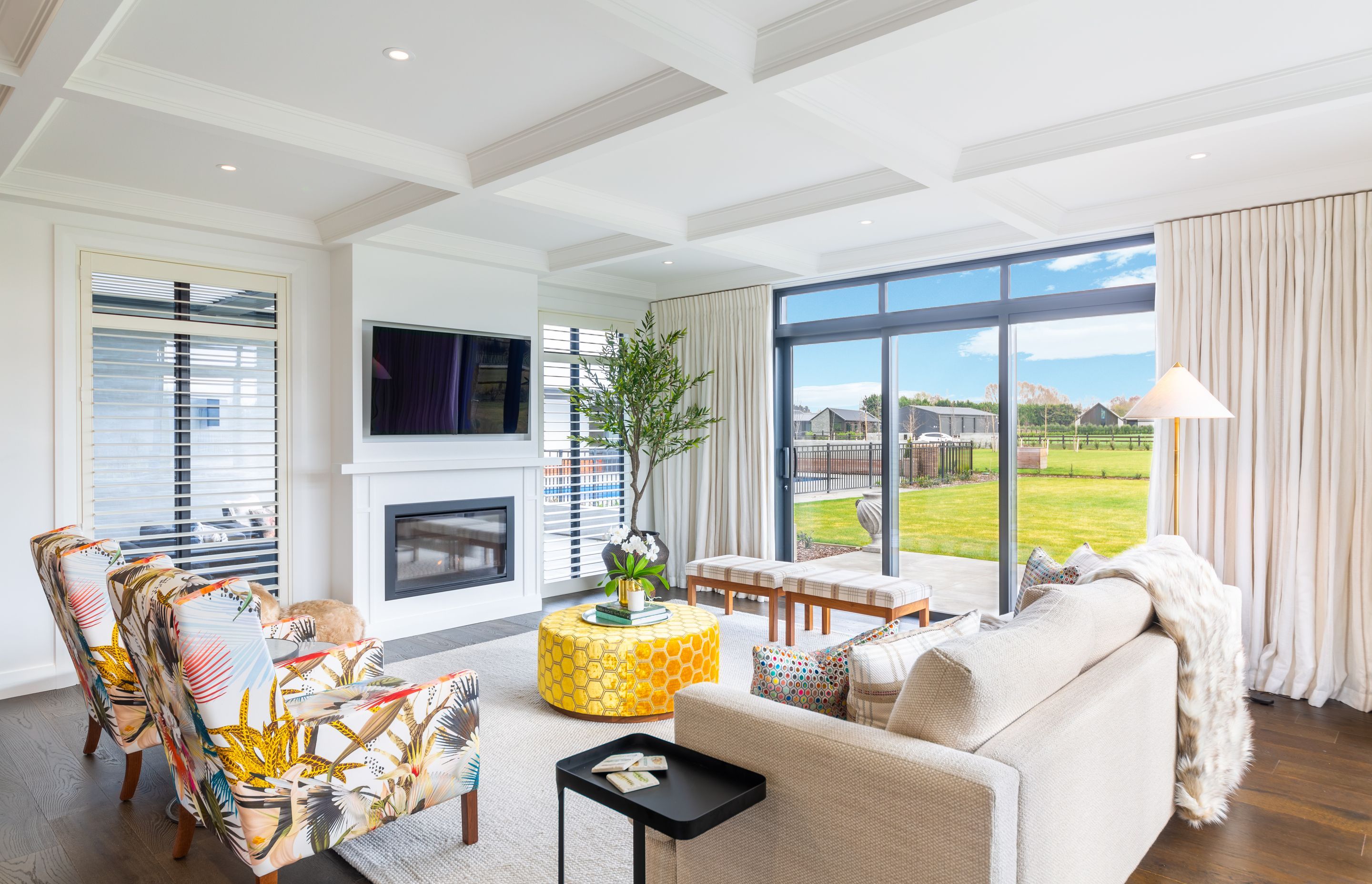 A gas fireplace warms the living space. and backs against an outdoor courtyard with louvred roof.