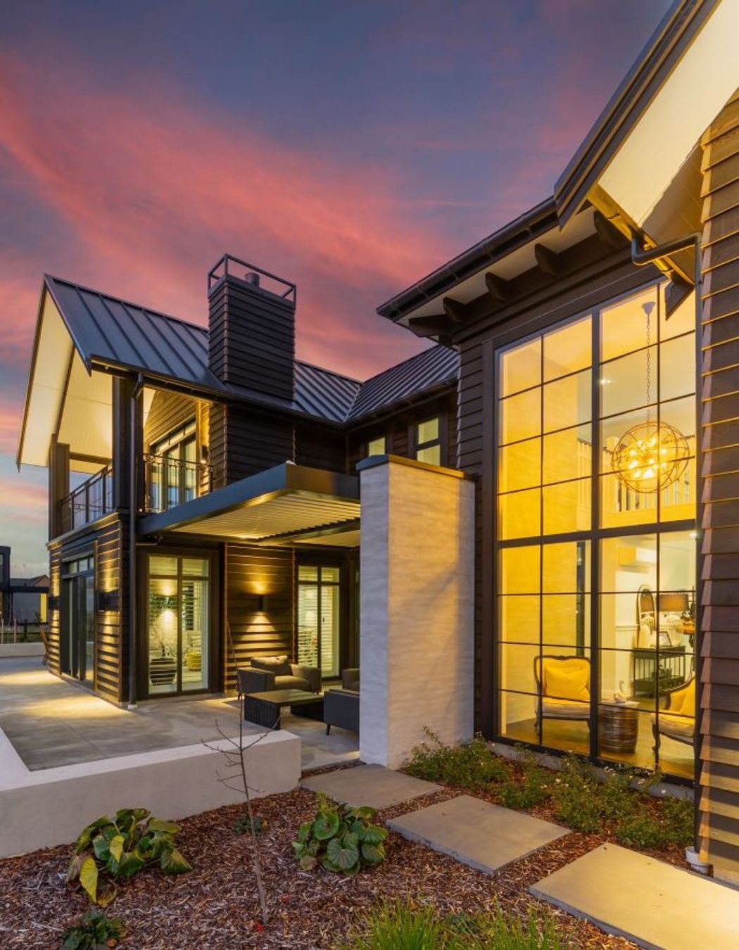 In this image you can see the interaction of all of the different building elements, from the foyer's double-height glazing, to the louvred outdoor courtyard and the gabled roofs with corbel details under the soffits.
