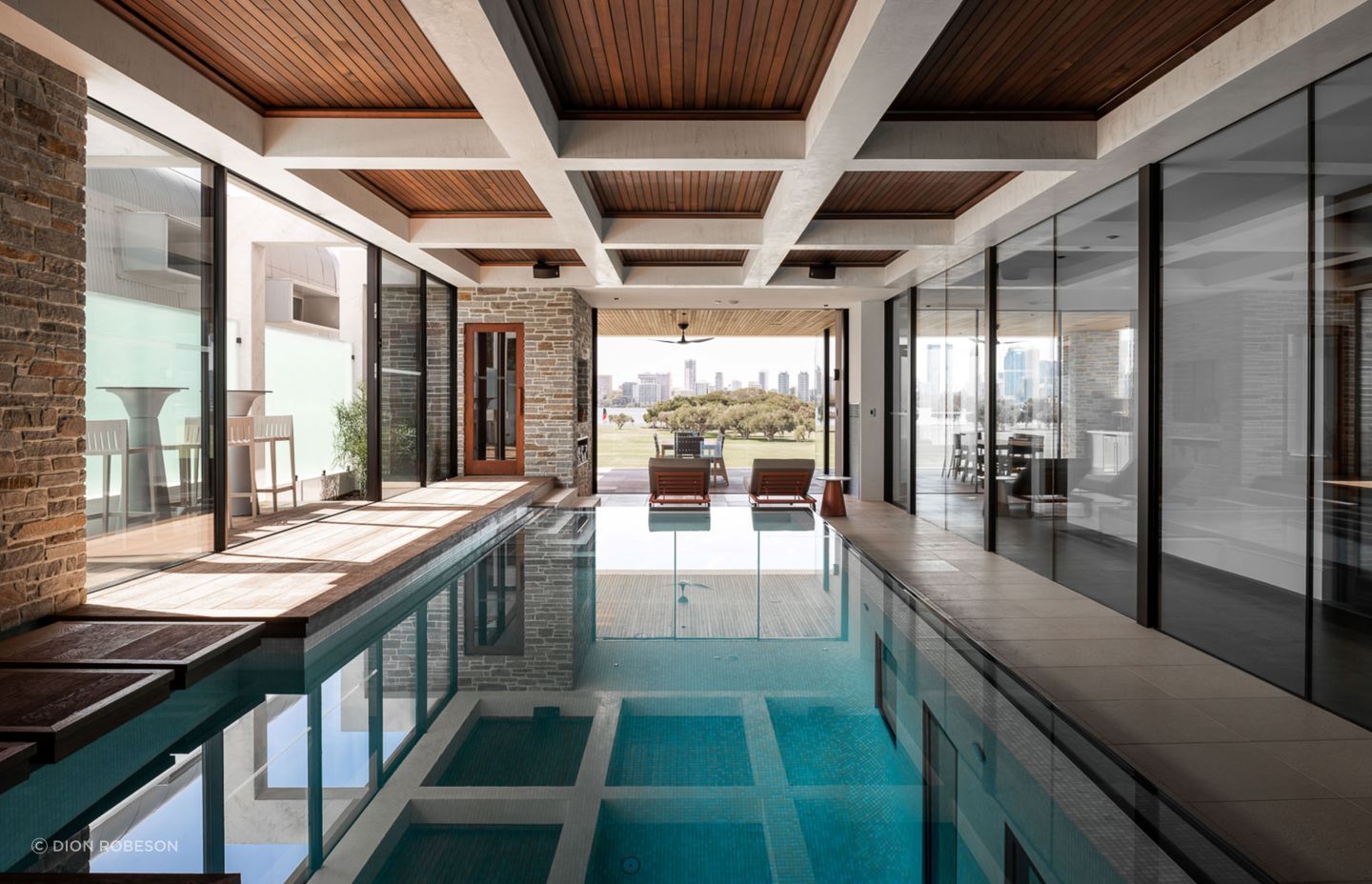 The indoor pool is accessed on the mid-level of the home, and has views directly out to the park and city beyond.