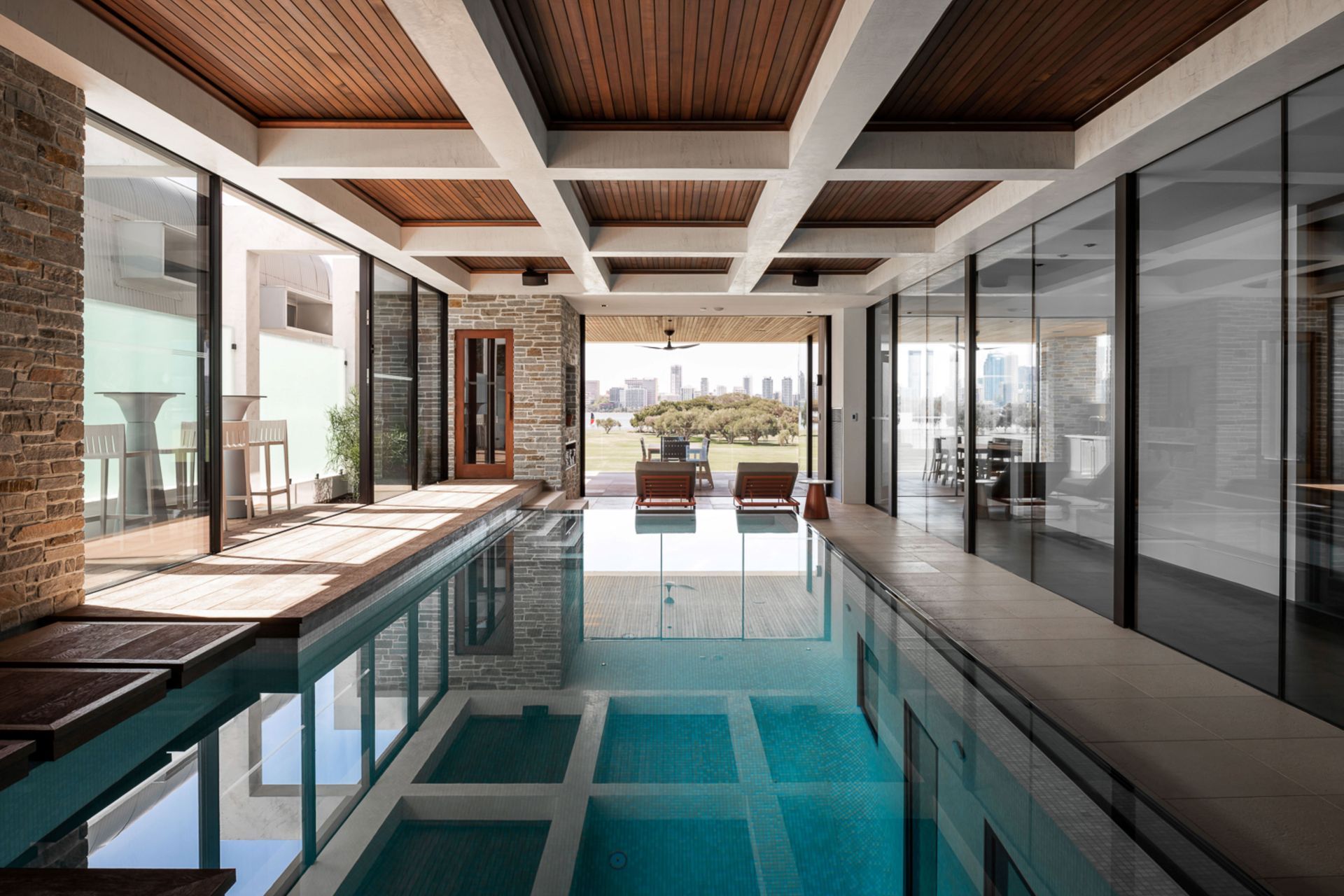 The indoor pool is accessed on the mid-level of the home, and has views directly out to the park and city beyond.