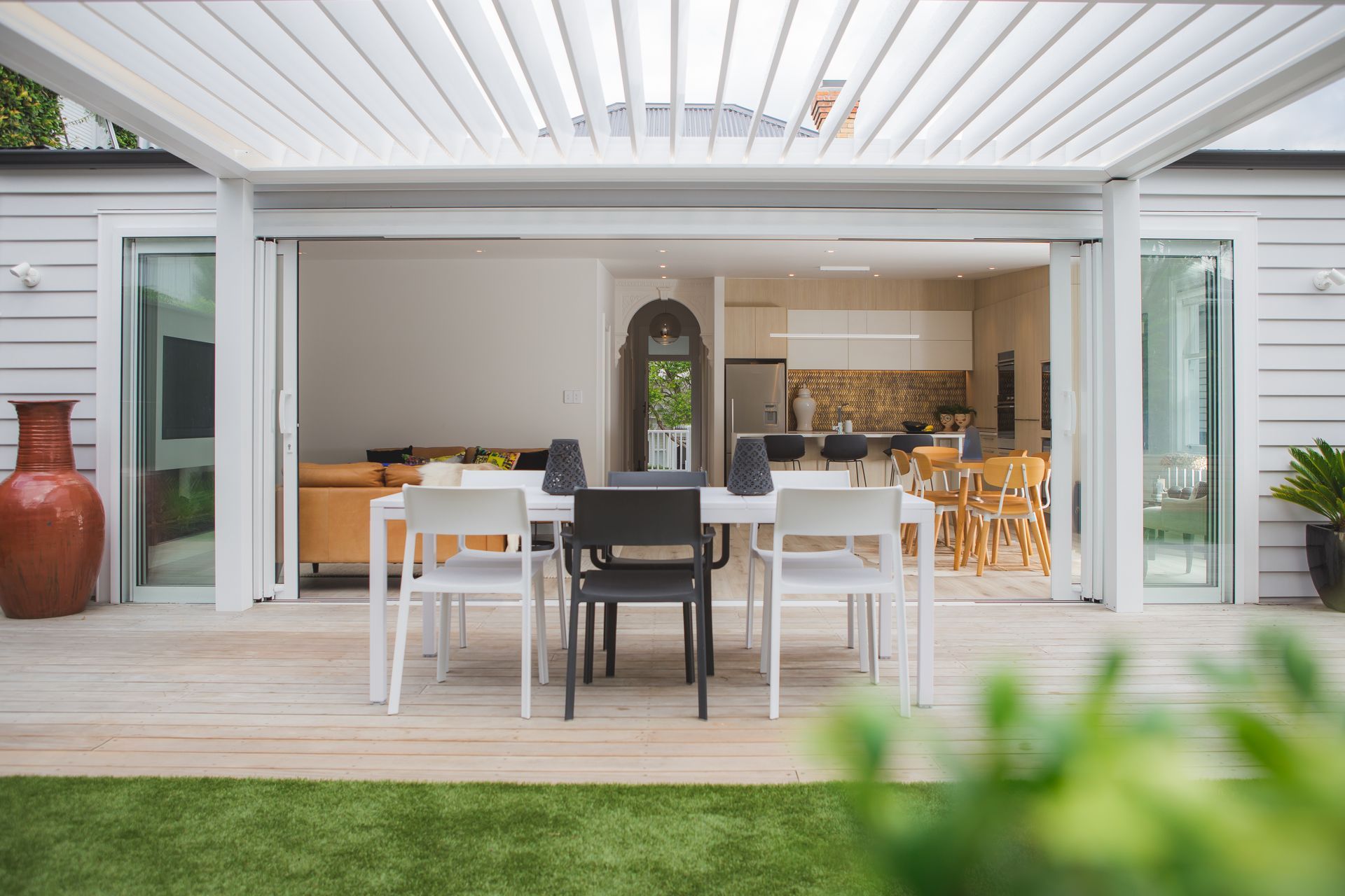 An extension to the interior living space, the outdoor entertaining area is shaded from a louvre system.