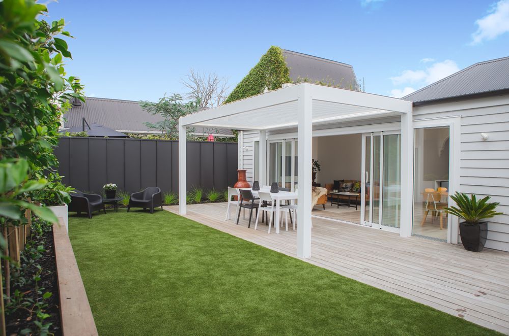 The deck and grass are at the same level to provide a seamless transition between the two.