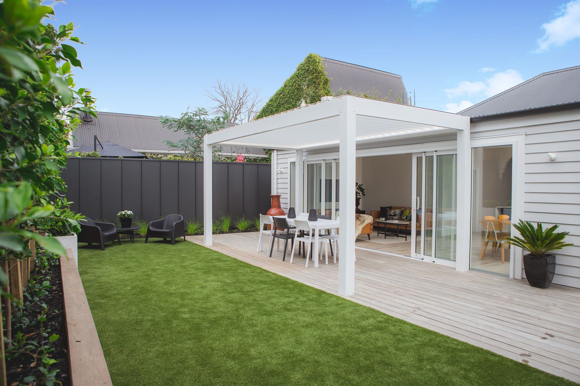 The deck and grass are at the same level to provide a seamless transition between the two.