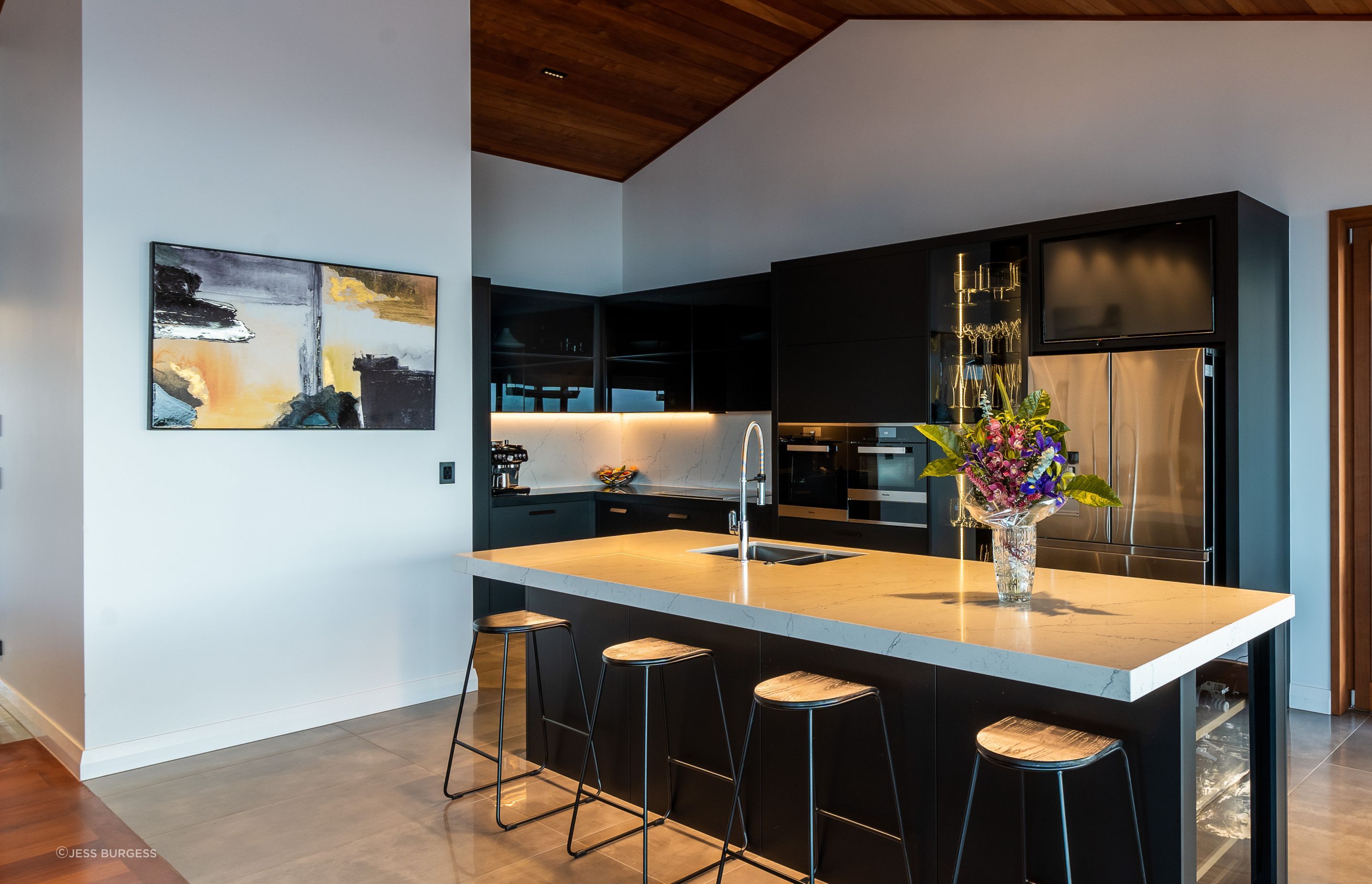The ovens in the kitchen are by Miele and the fridge is by Samsung. With a glassware display cabinet, two dishwashers and a Vintec wine fridge, it's a house made for entertaining.