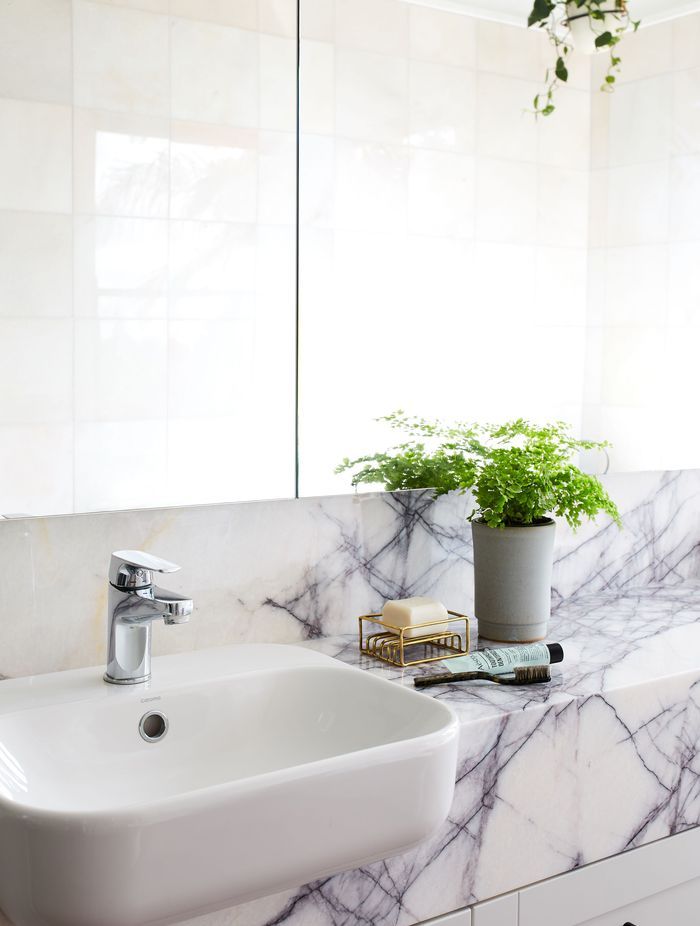 The master ensuite is modern yet tactile with a stone counter top.