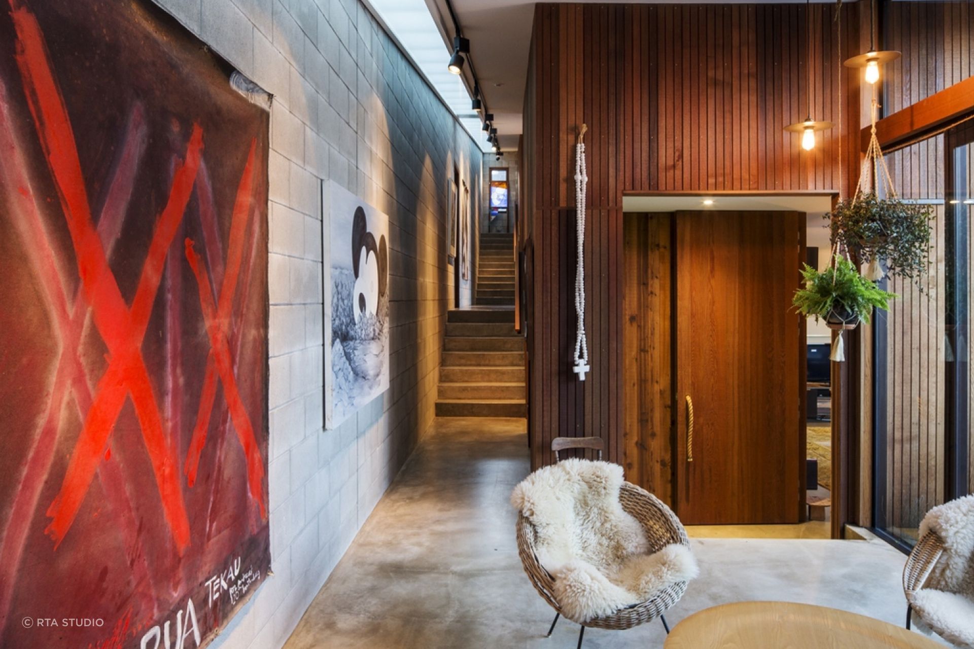 The concrete block circulation spine doubles as an art gallery.
