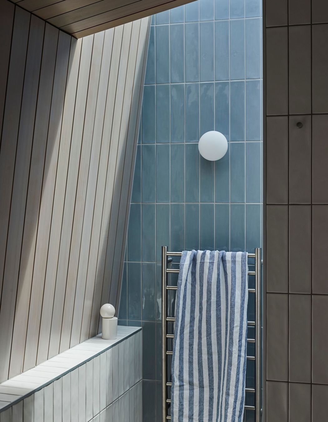 The entry to the shower in the master suite's bathroom, bathed in sun from the overhead skylight. | Photographer: Jackie Meiring