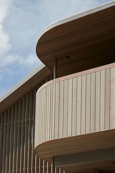 The western elevation’s sheltered upper deck, curved in design to soften its dominant height. | Photographer: Jackie Meiring
